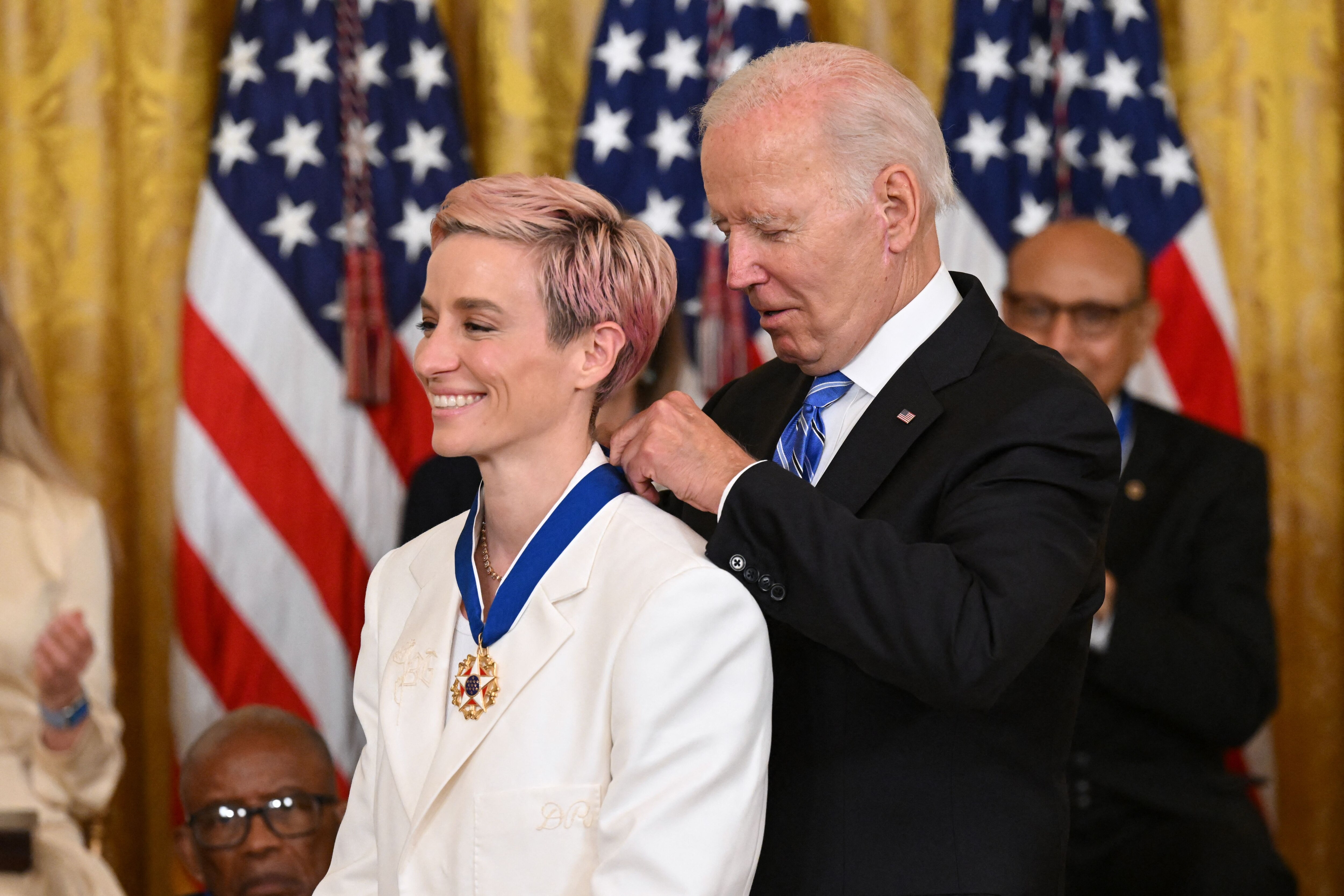 US President Joe Biden presents US soccer player Megan Rapinoe with the Presidential Medal of Freedom, the nation's highest civilian honor, during a ceremony honoring 17 recipients, in the East Room of the White House in Washington, DC, July 7, 2022. (Photo by SAUL LOEB / AFP) (Photo by SAUL LOEB/AFP via Getty Images) US President Joe Biden presents US soccer player Megan Rapinoe with the Presidential Medal of Freedom, the nation's highest civilian honor, during a ceremony honoring 17 recipients, in the East Room of the White House in Washington, DC, July 7, 2022. (Photo by SAUL LOEB / AFP) (Photo by SAUL LOEB/AFP via Getty Images)