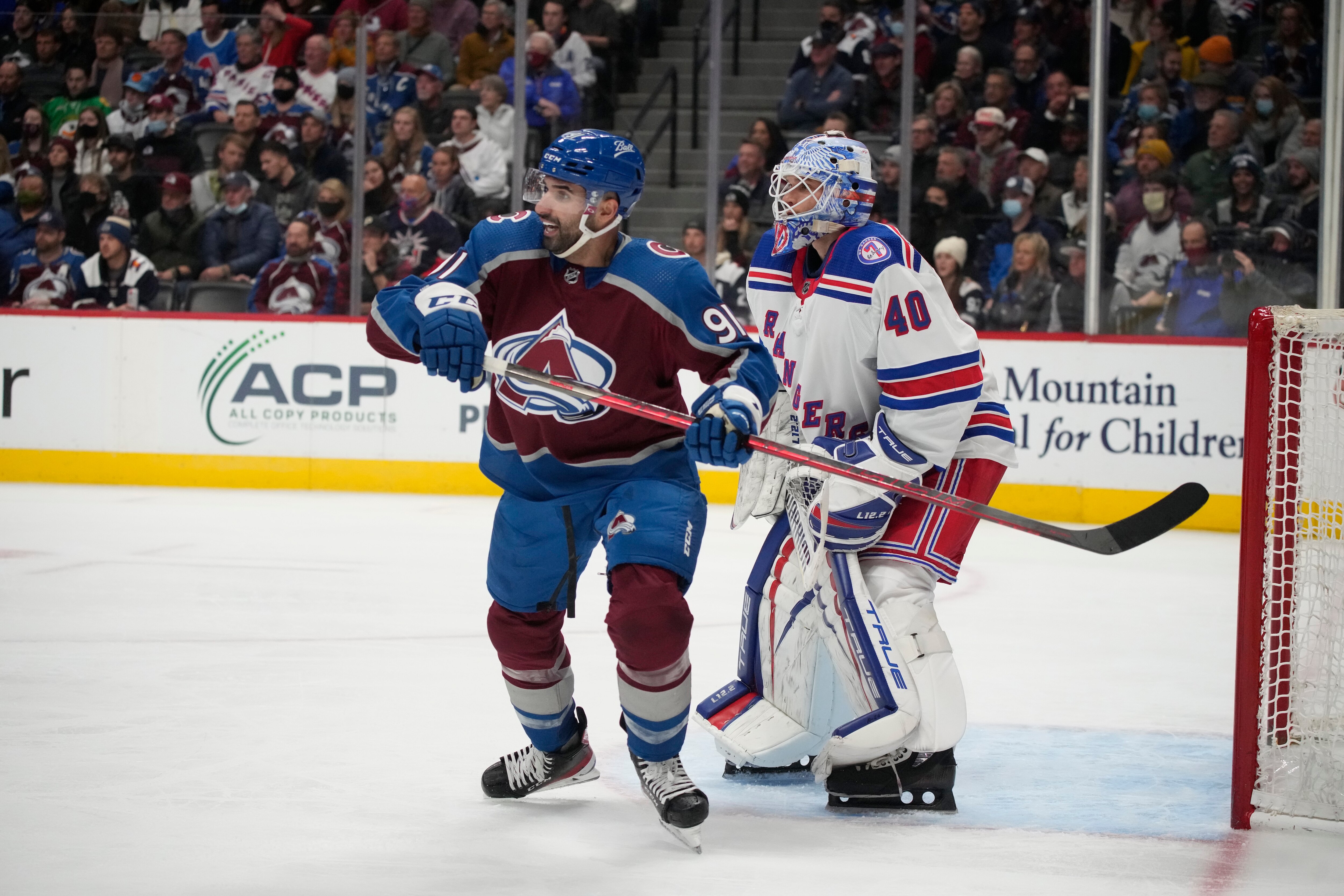 Colorado Avalanche center Nazem Kadri (91) and New York Rangers goaltender Alexandar Georgiev (40) in the third period of an NHL hockey game Tuesday, Dec. 14, 2021, in Denver. The Avalanche won 4-2. (AP Photo/David Zalubowski)