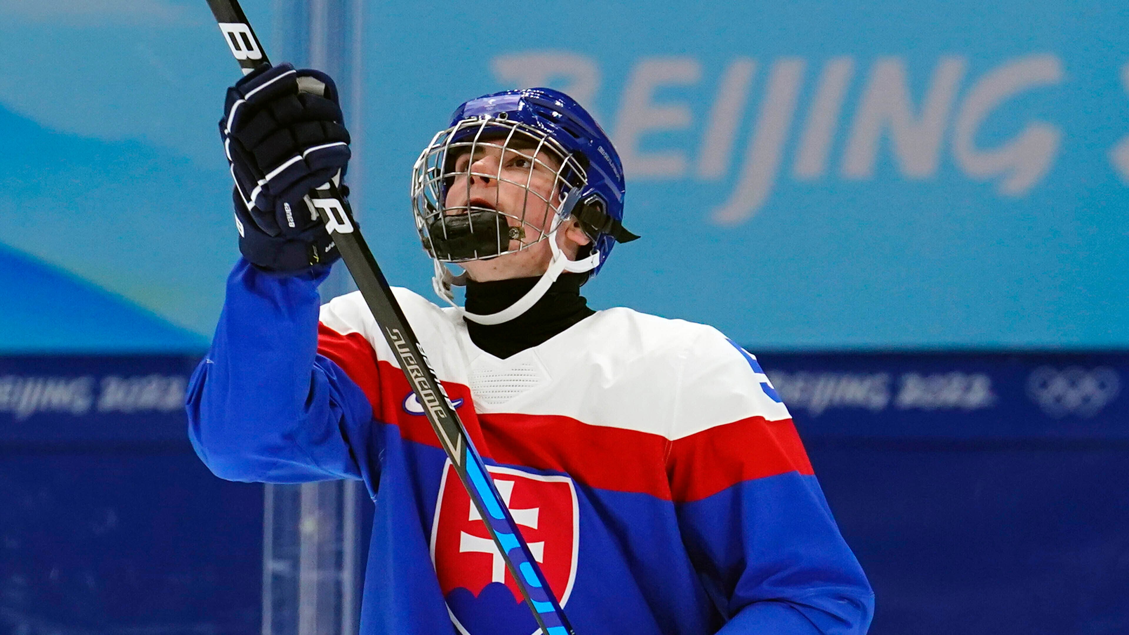 Slovakia's Simon Nemec tosses a puck in the air as he warms up before a preliminary round men's hockey game against Latvia at the 2022 Winter Olympics, Sunday, Feb. 13, 2022, in Beijing. (AP Photo/Matt Slocum)