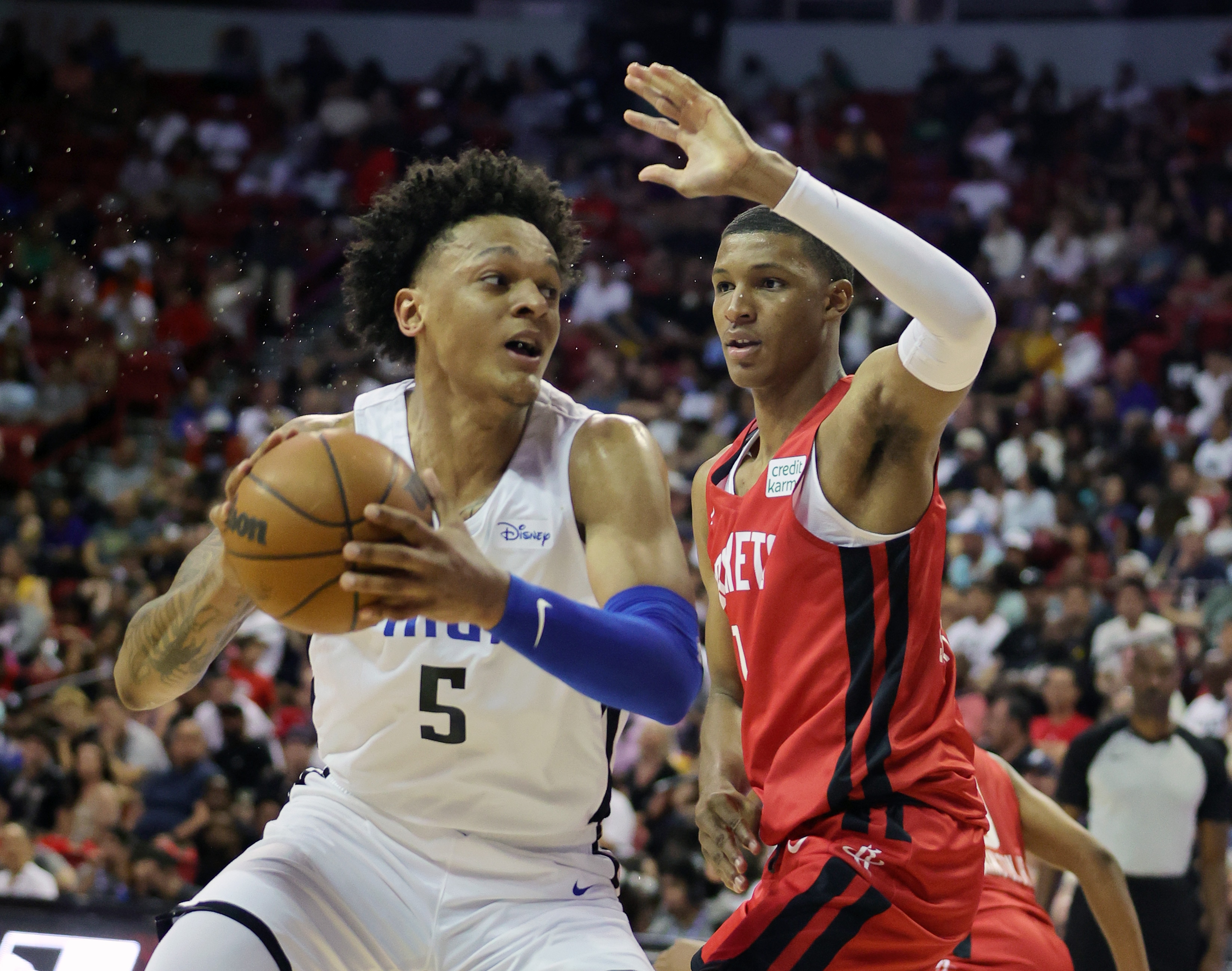LAS VEGAS, NEVADA - JULY 07: Paolo Banchero #5 of the Orlando Magic drives against Jabari Smith Jr. #1 of the Houston Rockets during the 2022 NBA Summer League at the Thomas & Mack Center on July 07, 2022 in Las Vegas, Nevada. NOTE TO USER: User expressly acknowledges and agrees that, by downloading and or using this photograph, User is consenting to the terms and conditions of the Getty Images License Agreement. (Photo by Ethan Miller/Getty Images)