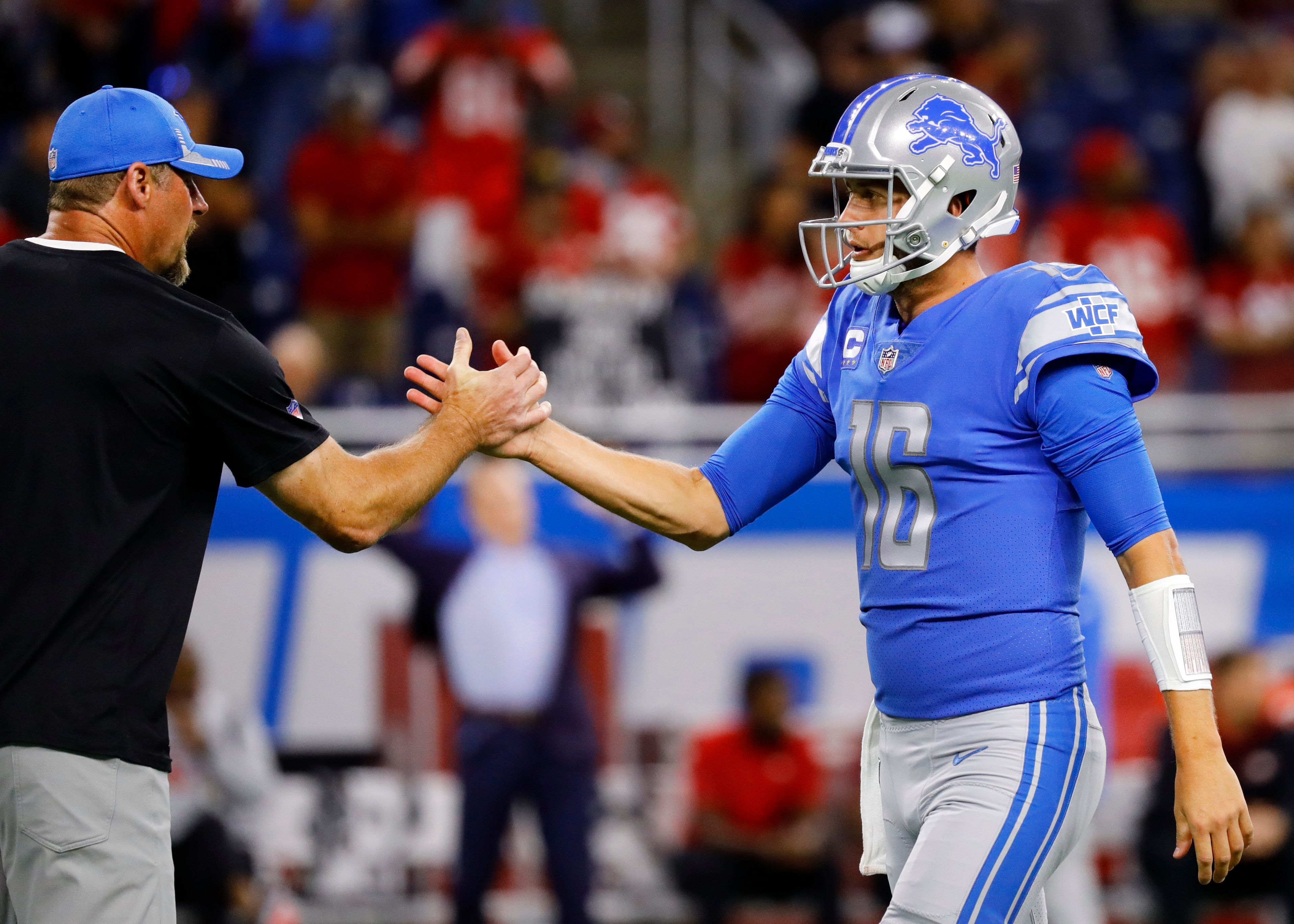 DETROIT, MICHIGAN - SEPTEMBER 12: Head coach Dan Campbell of the Detroit Lions congratulates Jared Goff #16 during the first half against the San Francisco 49ers at Ford Field on September 12, 2021 in Detroit, Michigan. (Photo by Leon Halip/Getty Images)