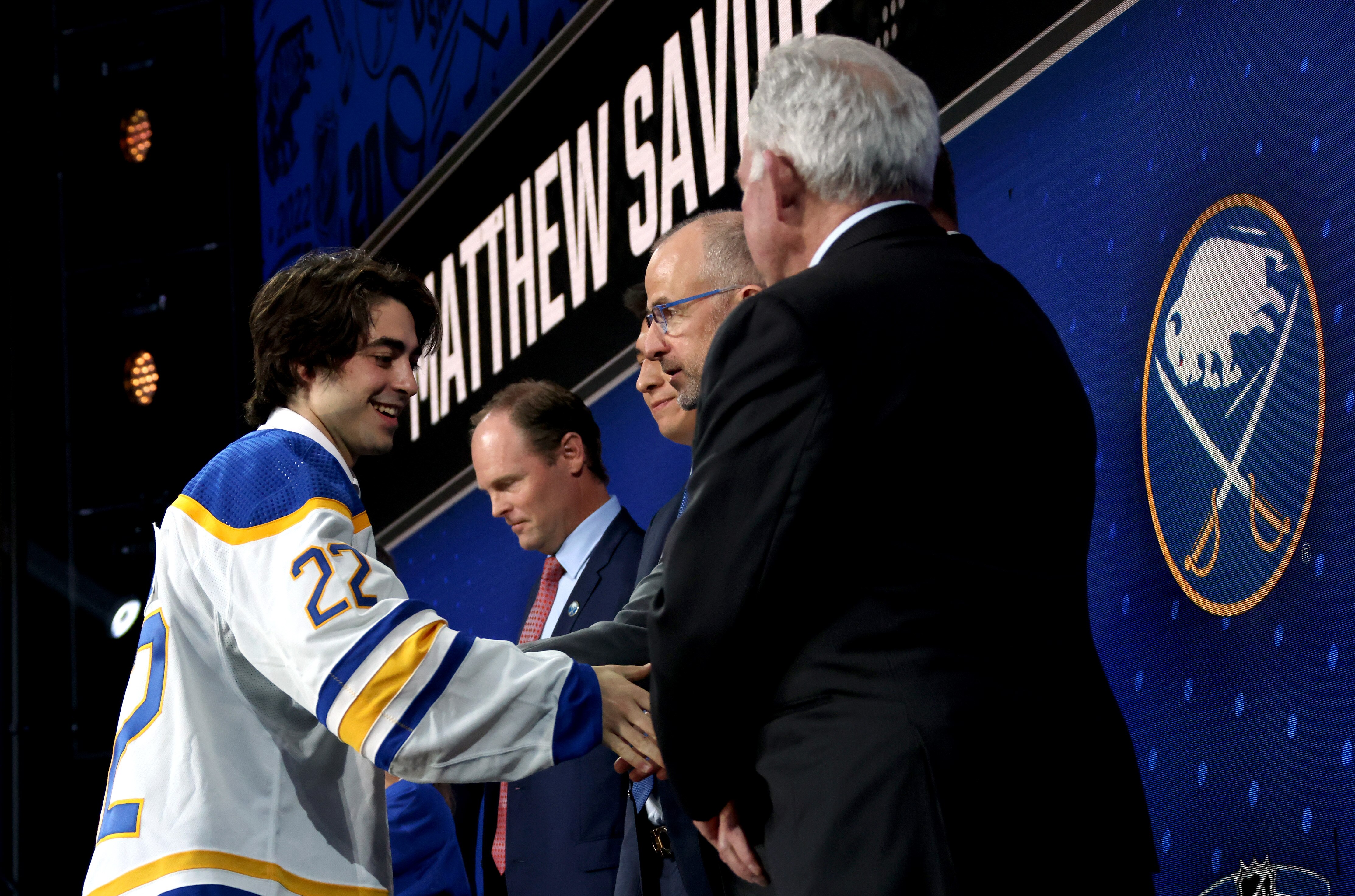 MONTREAL, QUEBEC - JULY 07: Matthew Savoie shakes hands onstage with team personnel after being selected ninth overall by the Buffalo Sabres during the first round of the 2022 Upper Deck NHL Draft at Bell Centre on July 07, 2022 in Montreal, Quebec. (Photo by Dave Sandford/NHLI via Getty Images)