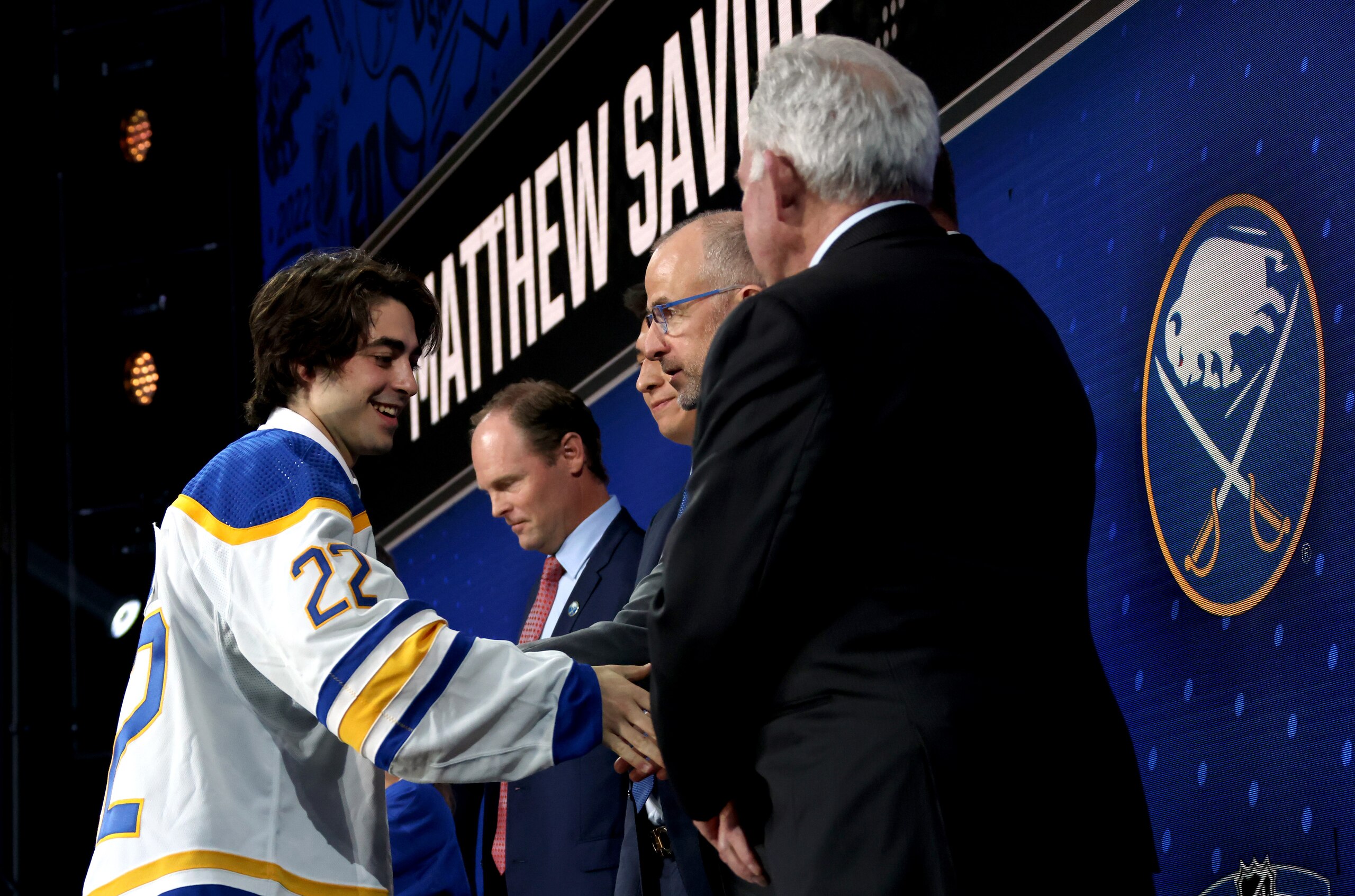 MONTREAL, QUEBEC - JULY 07: Matthew Savoie shakes hands onstage with team personnel after being selected ninth overall by the Buffalo Sabres during the first round of the 2022 Upper Deck NHL Draft at Bell Centre on July 07, 2022 in Montreal, Quebec. (Photo by Dave Sandford/NHLI via Getty Images)