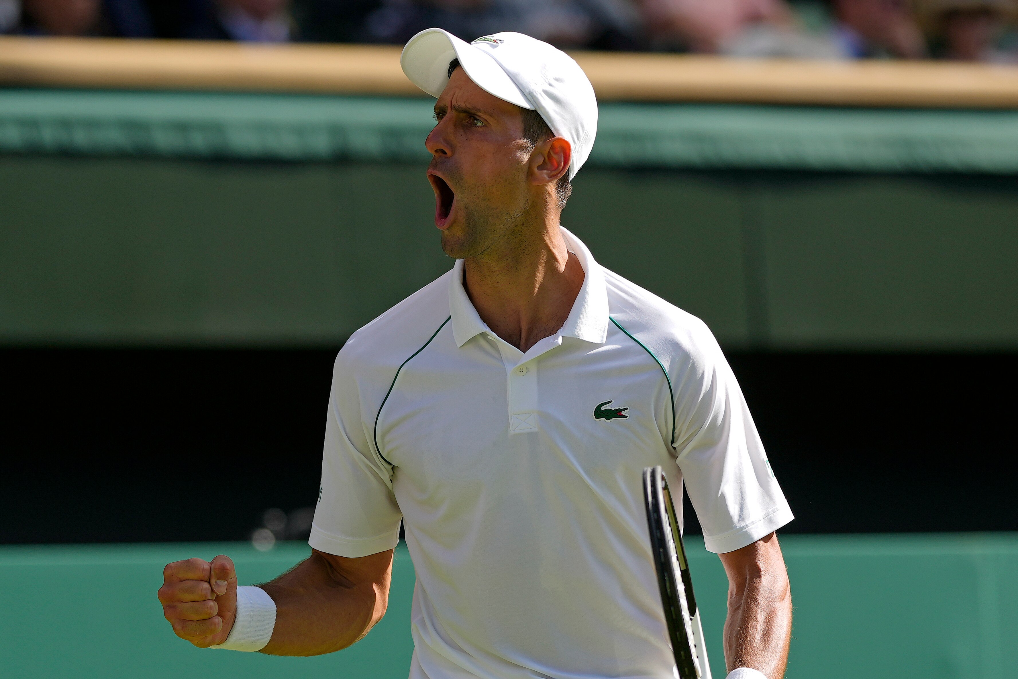 Serbia's Novak Djokovic reacts as he wins a point against Britain's Cameron Norrie in a men's singles semifinal on day twelve of the Wimbledon tennis championships in London, Friday, July 8, 2022. (AP Photo/Alastair Grant)