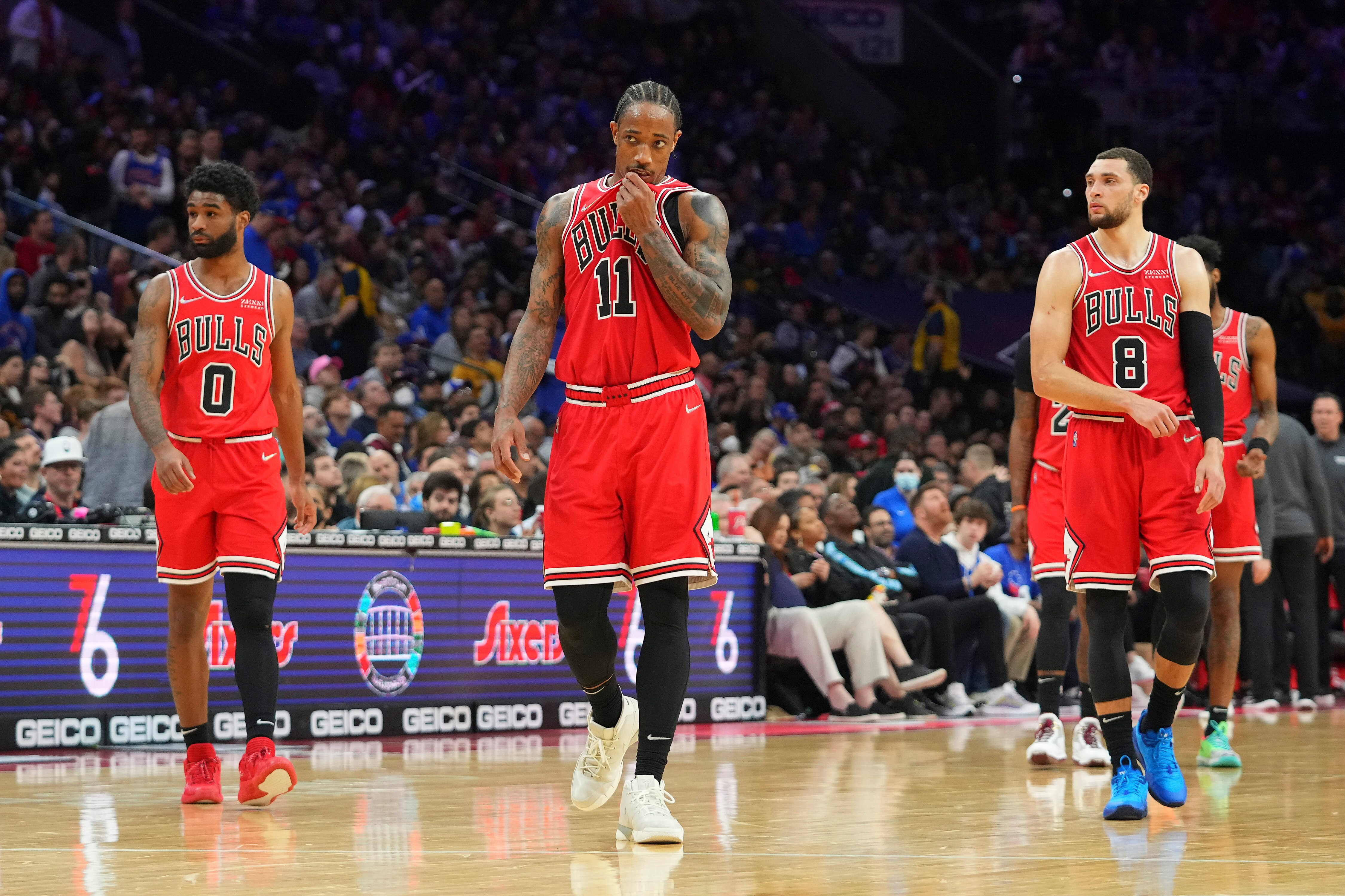PHILADELPHIA, PA - MARCH 07: Coby White #0, DeMar DeRozan #11, and Zach LaVine #8 of the Chicago Bulls look on against the Philadelphia 76ers at the Wells Fargo Center on March 7, 2022 in Philadelphia, Pennsylvania. The 76ers defeated the Bulls 121-106. NOTE TO USER: User expressly acknowledges and agrees that, by downloading and or using this photograph, User is consenting to the terms and conditions of the Getty Images License Agreement. (Photo by Mitchell Leff/Getty Images)