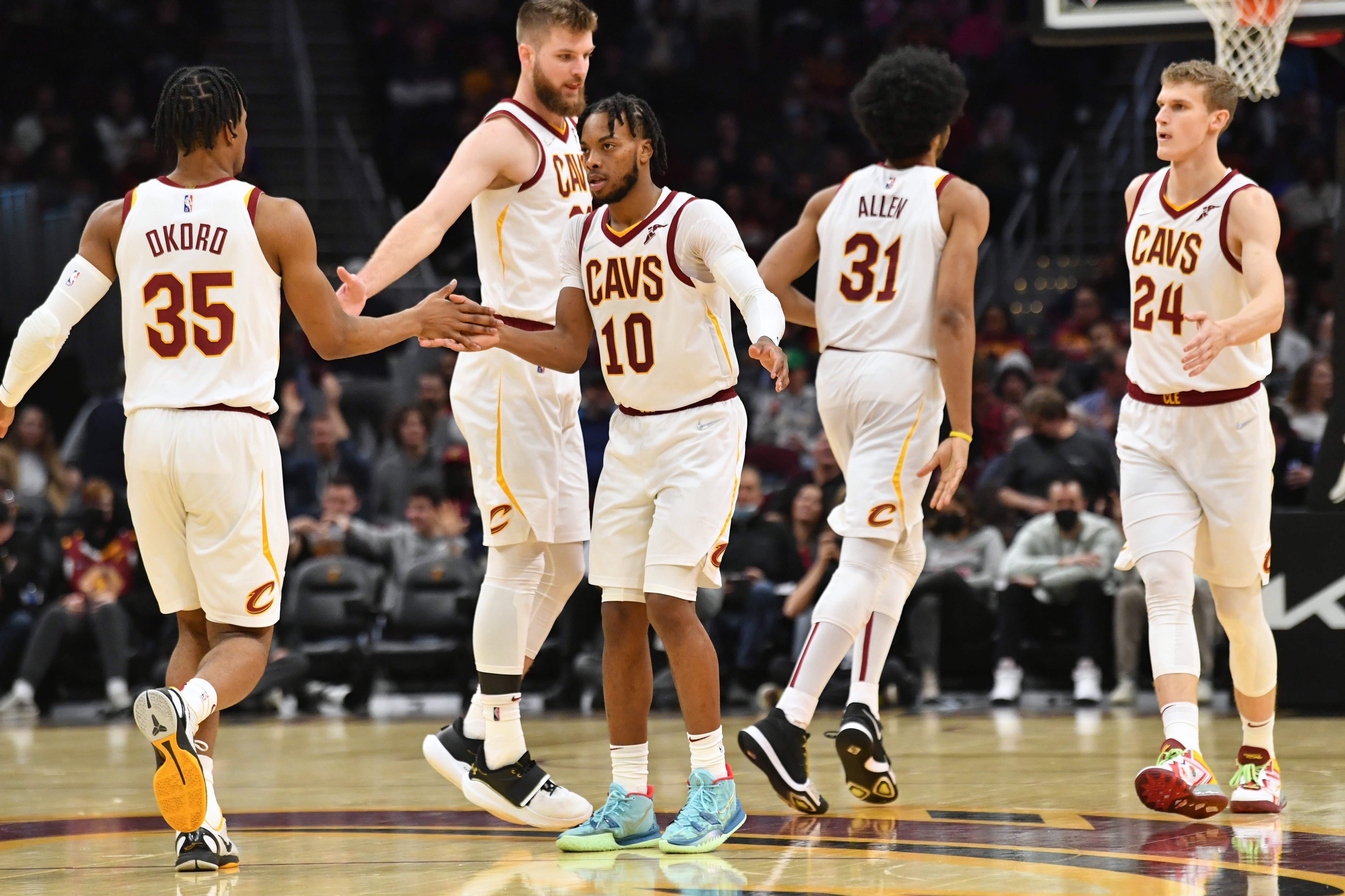 CLEVELAND, OHIO - DECEMBER 15: Isaac Okoro #35 Darius Garland #10 Dean Wade #32 Jarrett Allen #31 and Lauri Markkanen #24 of the Cleveland Cavaliers celebrates during the third quarter against the Houston Rockets at Rocket Mortgage Fieldhouse on December 15, 2021 in Cleveland, Ohio. The Cavaliers defeated the Rockets 124-89. NOTE TO USER: User expressly acknowledges and agrees that, by downloading and/or using this photograph, user is consenting to the terms and conditions of the Getty Images License Agreement. (Photo by Jason Miller/Getty Images)