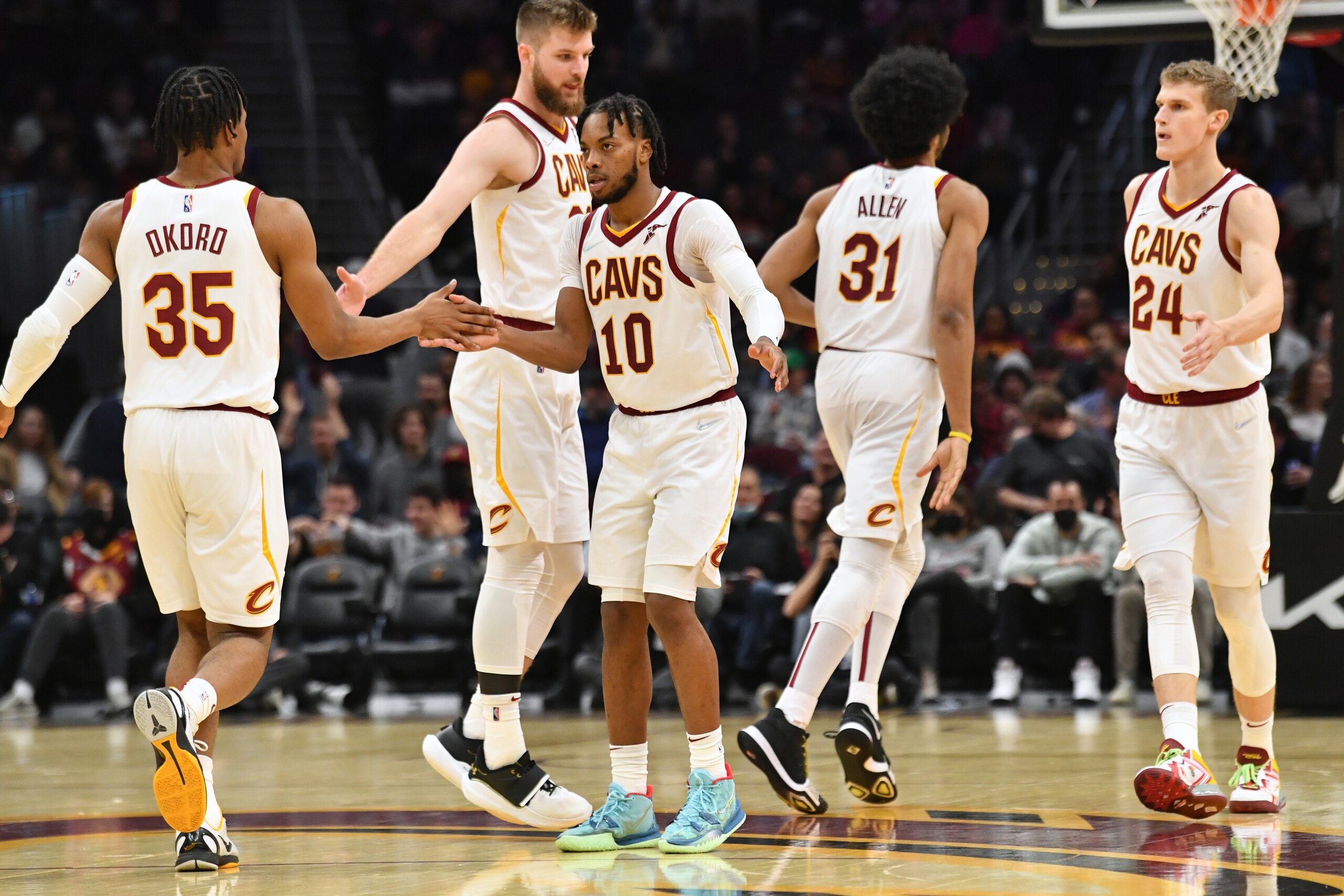 CLEVELAND, OHIO - DECEMBER 15: Isaac Okoro #35 Darius Garland #10 Dean Wade #32 Jarrett Allen #31 and Lauri Markkanen #24 of the Cleveland Cavaliers celebrates during the third quarter against the Houston Rockets at Rocket Mortgage Fieldhouse on December 15, 2021 in Cleveland, Ohio. The Cavaliers defeated the Rockets 124-89. NOTE TO USER: User expressly acknowledges and agrees that, by downloading and/or using this photograph, user is consenting to the terms and conditions of the Getty Images License Agreement. (Photo by Jason Miller/Getty Images)