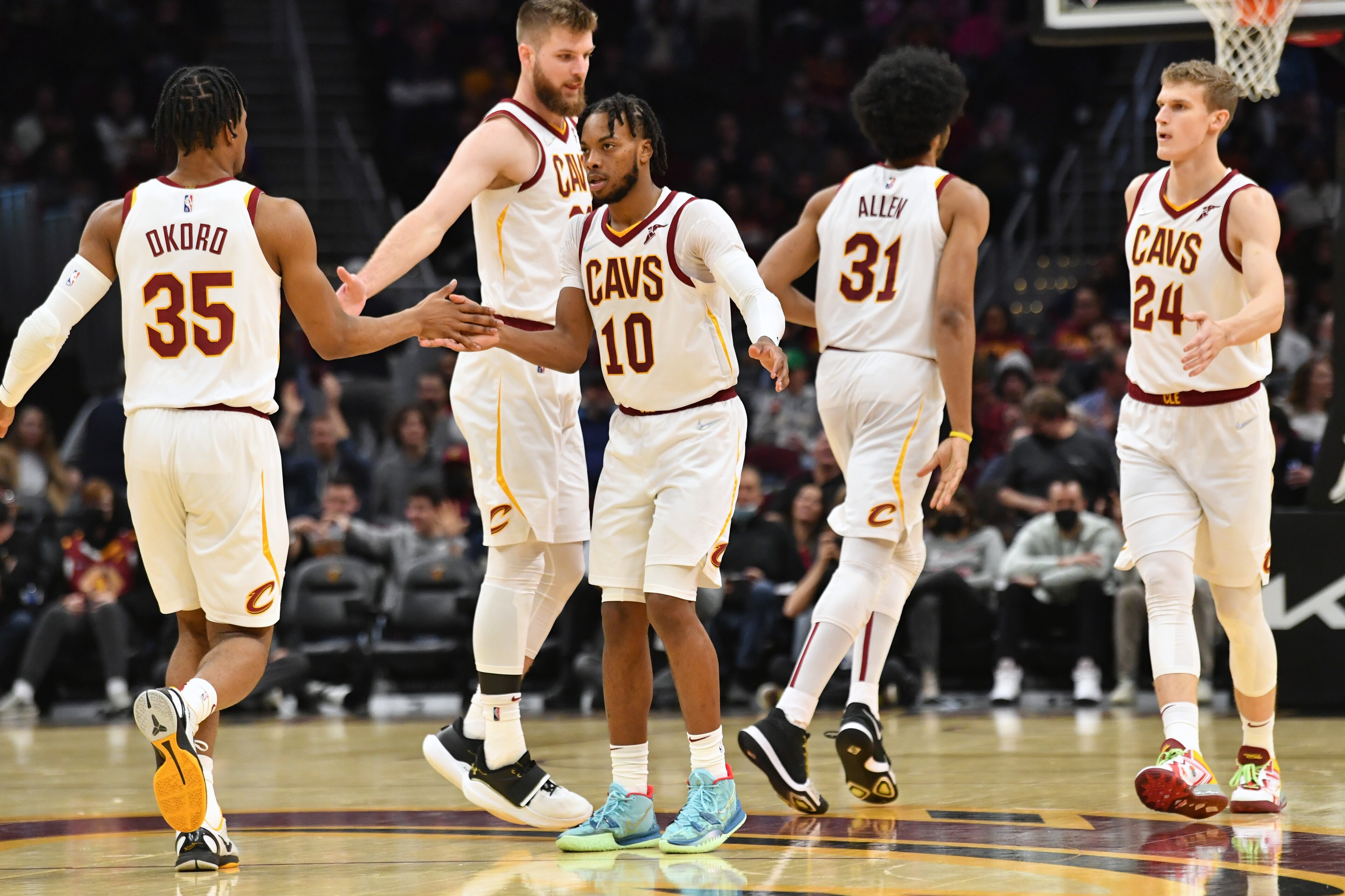 CLEVELAND, OHIO - DECEMBER 15: Isaac Okoro #35 Darius Garland #10 Dean Wade #32 Jarrett Allen #31 and Lauri Markkanen #24 of the Cleveland Cavaliers celebrates during the third quarter against the Houston Rockets at Rocket Mortgage Fieldhouse on December 15, 2021 in Cleveland, Ohio. The Cavaliers defeated the Rockets 124-89. NOTE TO USER: User expressly acknowledges and agrees that, by downloading and/or using this photograph, user is consenting to the terms and conditions of the Getty Images License Agreement. (Photo by Jason Miller/Getty Images)