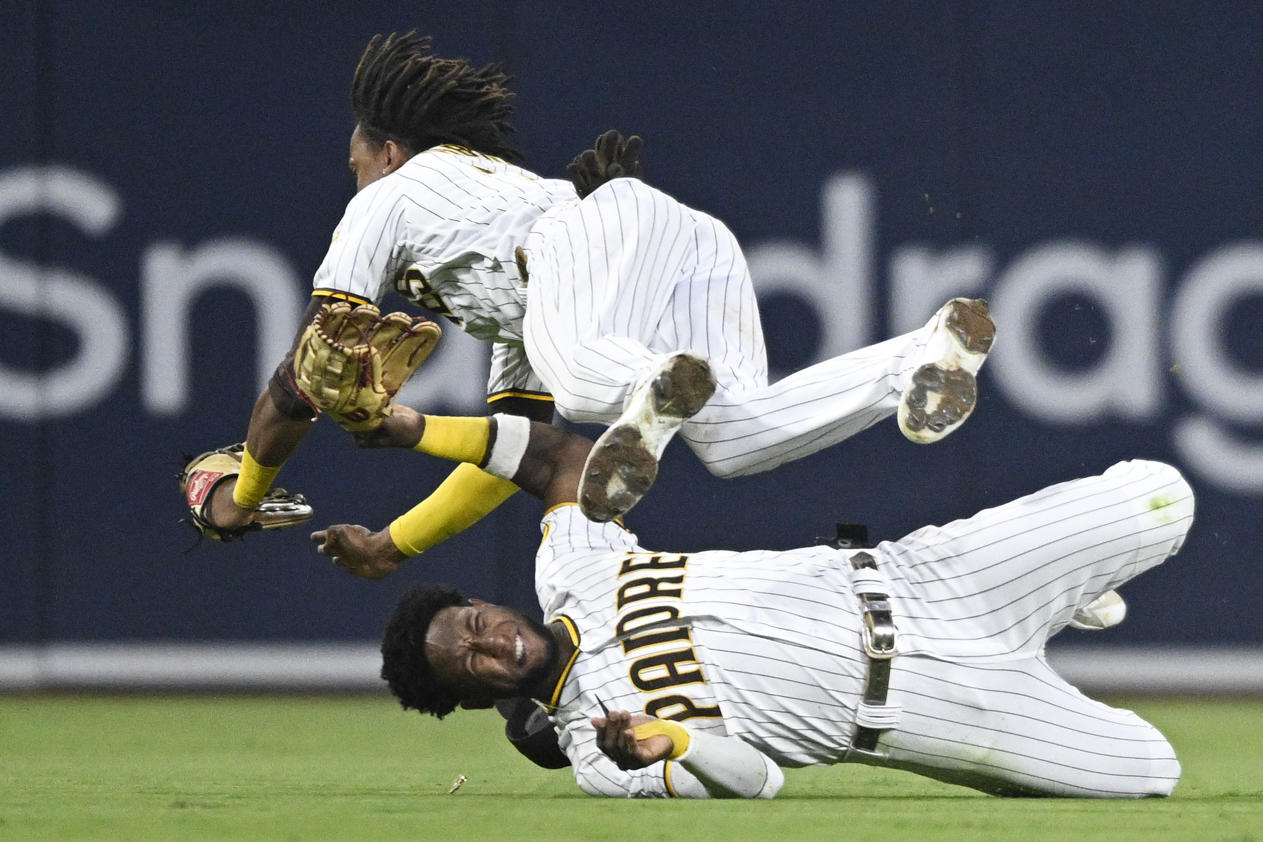 SAN DIEGO, CA - JULY 7:   C.J. Abrams #77 of the San Diego Padres, right, collides with Jurickson Profar #10 as he makes a catch on a ball hit by Tommy La Stella #8 of the San Francisco Giants during the fifth inning of a baseball game July 7, 2022 at Petco Park in San Diego, California. Profar was injured on the play. (Photo by Denis Poroy/Getty Images)