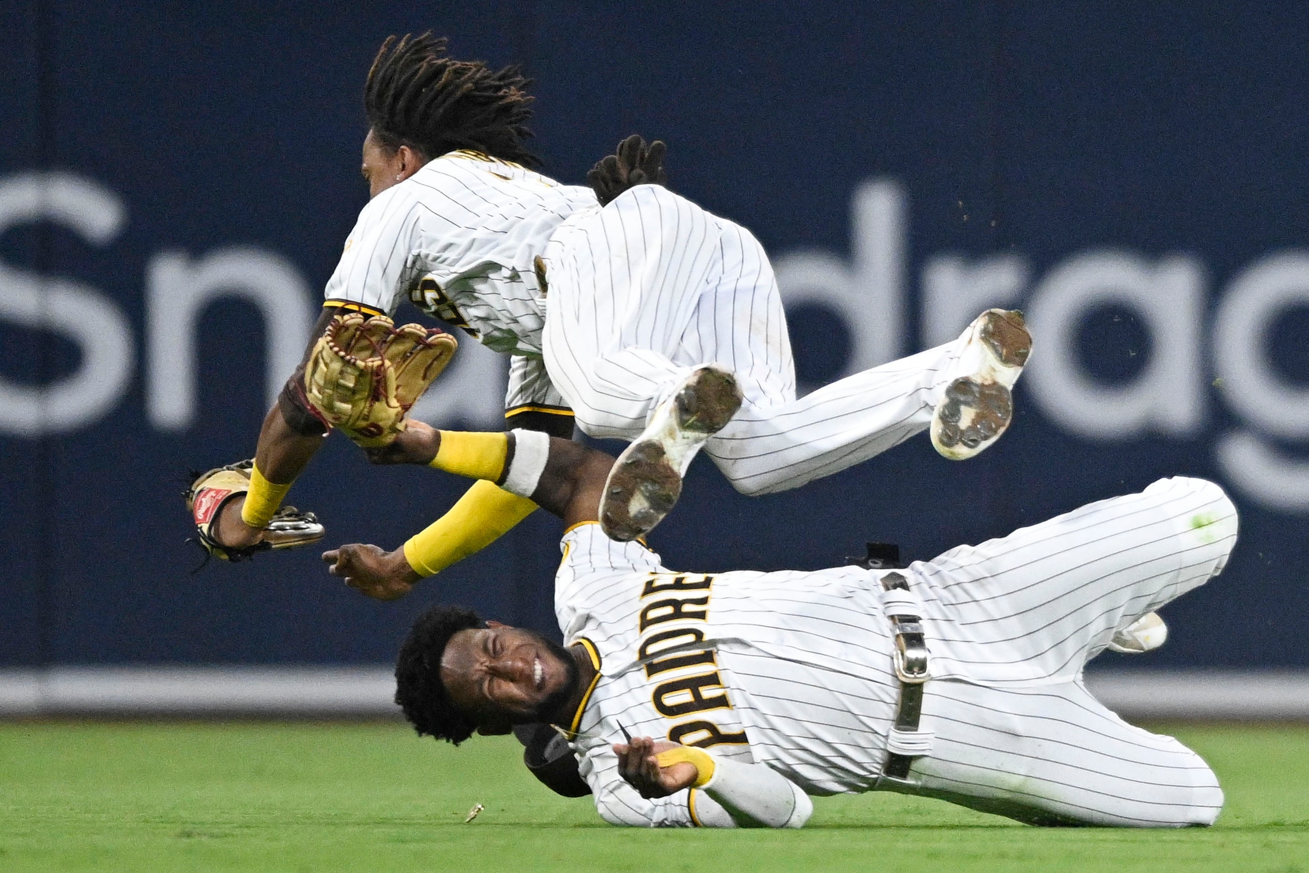 SAN DIEGO, CA - JULY 7:   C.J. Abrams #77 of the San Diego Padres, right, collides with Jurickson Profar #10 as he makes a catch on a ball hit by Tommy La Stella #8 of the San Francisco Giants during the fifth inning of a baseball game July 7, 2022 at Petco Park in San Diego, California. Profar was injured on the play. (Photo by Denis Poroy/Getty Images)