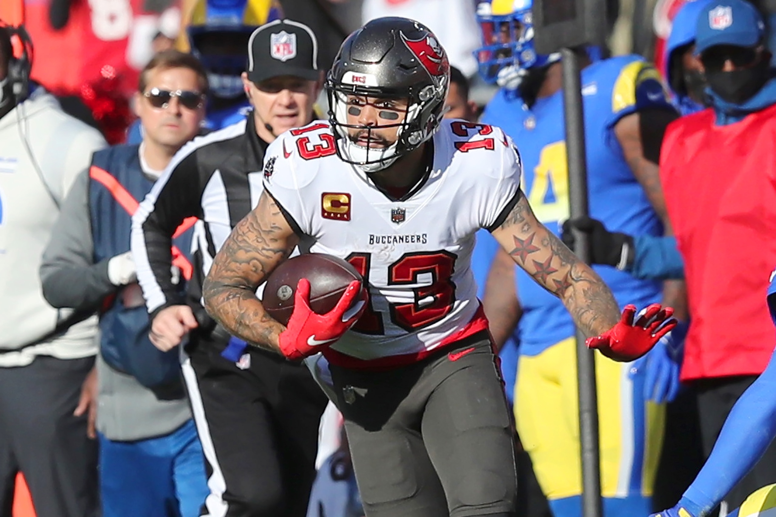 TAMPA, FL - JANUARY 23: Tampa Bay Buccaneers Wide Receiver Mike Evans (13) attempts to get past the Rams defenders during the NFC Divisional game between the Los Angeles Rams and the Tampa Bay Buccaneers on January 23, 2022 at Raymond James Stadium in Tampa, Florida. (Photo by Cliff Welch/Icon Sportswire via Getty Images) TAMPA, FL - JANUARY 23: Tampa Bay Buccaneers Wide Receiver Mike Evans (13) attempts to get past the Rams defenders during the NFC Divisional game between the Los Angeles Rams and the Tampa Bay Buccaneers on January 23, 2022 at Raymond James Stadium in Tampa, Florida. (Photo by Cliff Welch/Icon Sportswire via Getty Images)