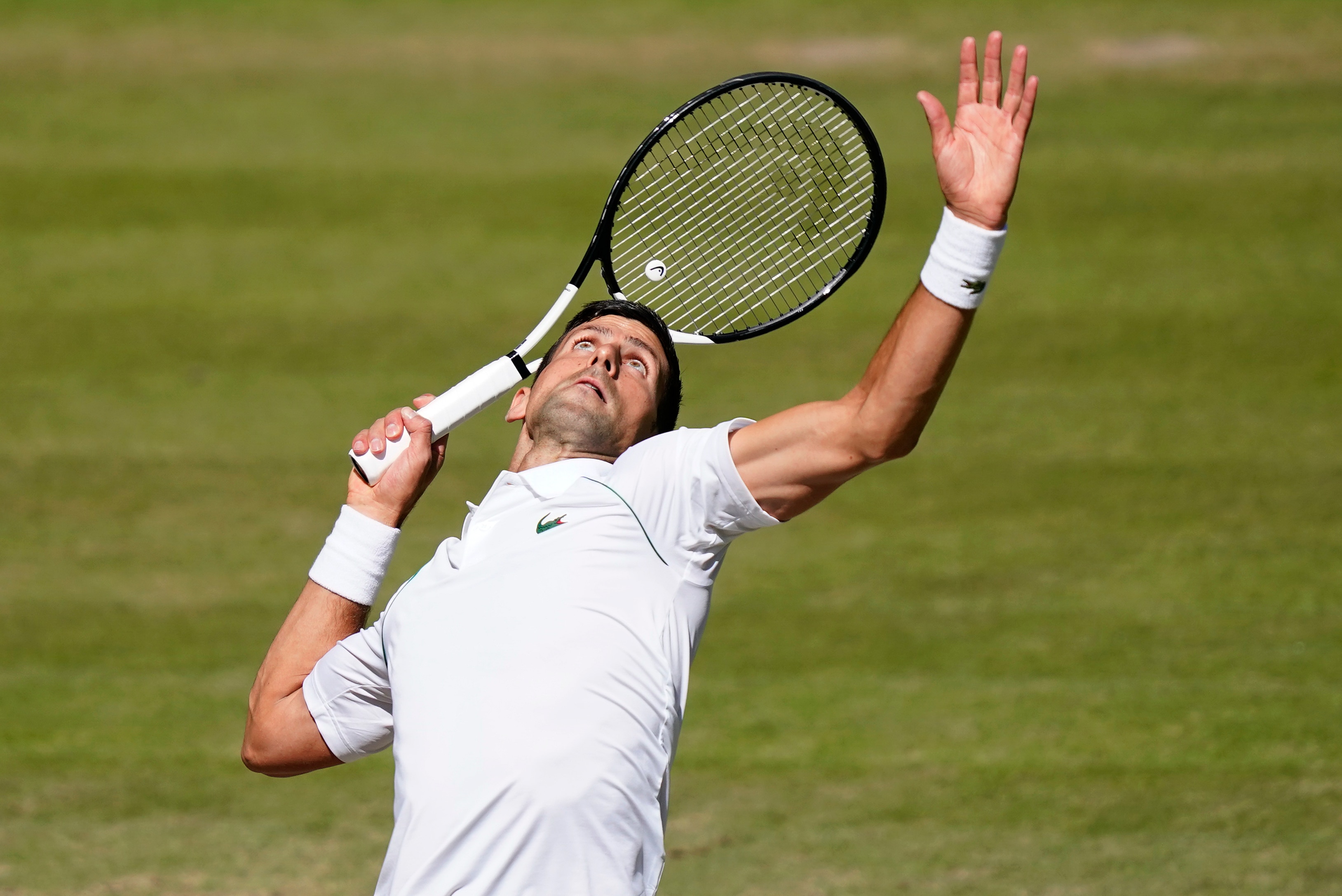 Serbia's Novak Djokovic serves to Britain's Cameron Norrie in a men's singles semifinal on day twelve of the Wimbledon tennis championships in London, Friday, July 8, 2022. (AP Photo/Gerald Herbert)