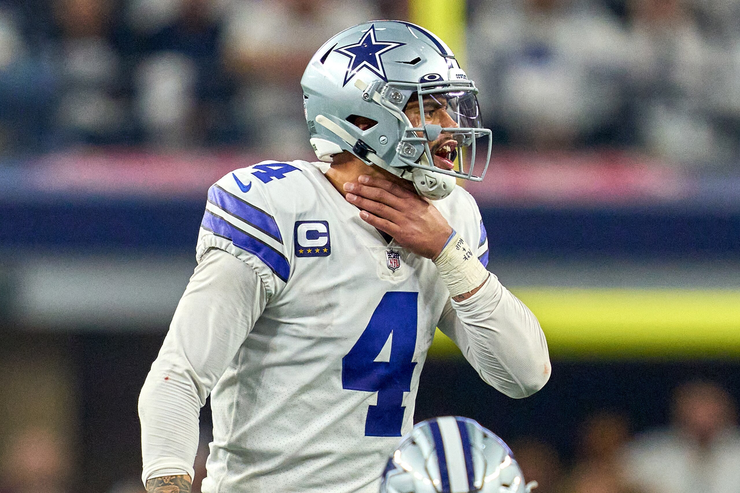 ARLINGTON, TX - JANUARY 16: Dallas Cowboys quarterback Dak Prescott (4) signals for a play by grabbing his throat during the NFC Wild Card game between the San Francisco 49ers and the Dallas Cowboys on January 16, 2022 at AT&T Stadium in Arlington, TX. (Photo by Robin Alam/Icon Sportswire via Getty Images) ARLINGTON, TX - JANUARY 16: Dallas Cowboys quarterback Dak Prescott (4) signals for a play by grabbing his throat during the NFC Wild Card game between the San Francisco 49ers and the Dallas Cowboys on January 16, 2022 at AT&T Stadium in Arlington, TX. (Photo by Robin Alam/Icon Sportswire via Getty Images)