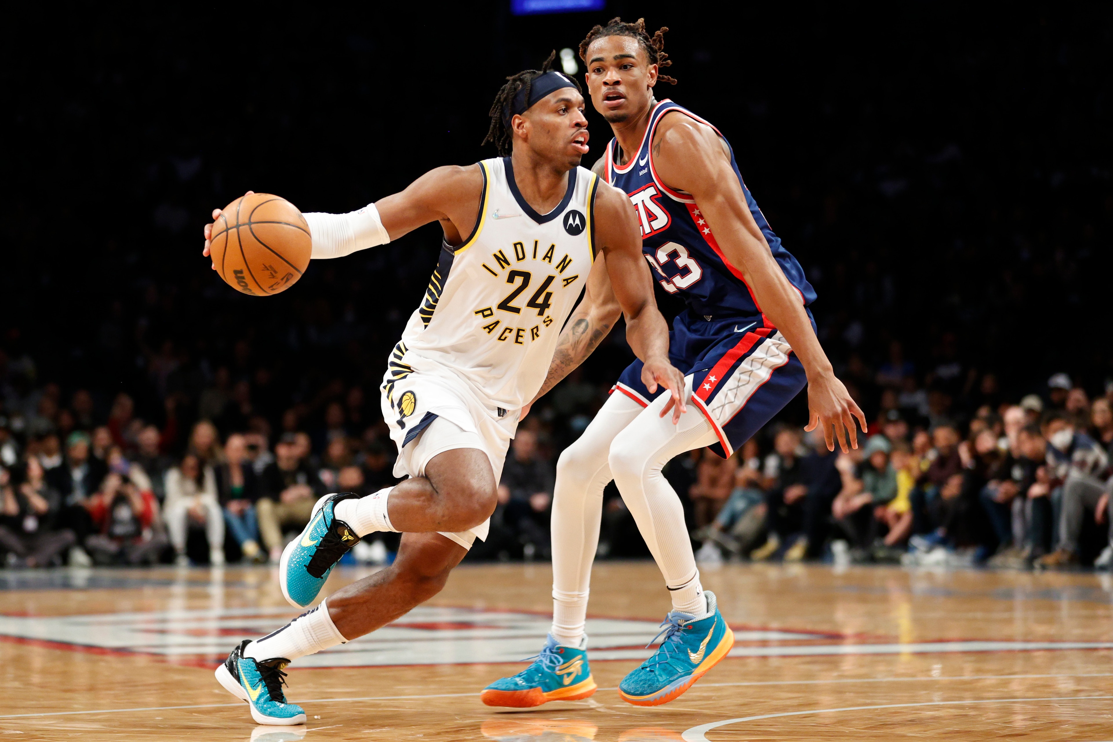 NEW YORK, NEW YORK - APRIL 10: Buddy Hield #24 of the Indiana Pacers dribbles as Nic Claxton #33 of the Brooklyn Nets defends during the second half at Barclays Center on April 10, 2022 in the Brooklyn borough of New York City. The Nets won 134-126. NOTE TO USER: User expressly acknowledges and agrees that, by downloading and or using this photograph, User is consenting to the terms and conditions of the Getty Images License Agreement. (Photo by Sarah Stier/Getty Images)