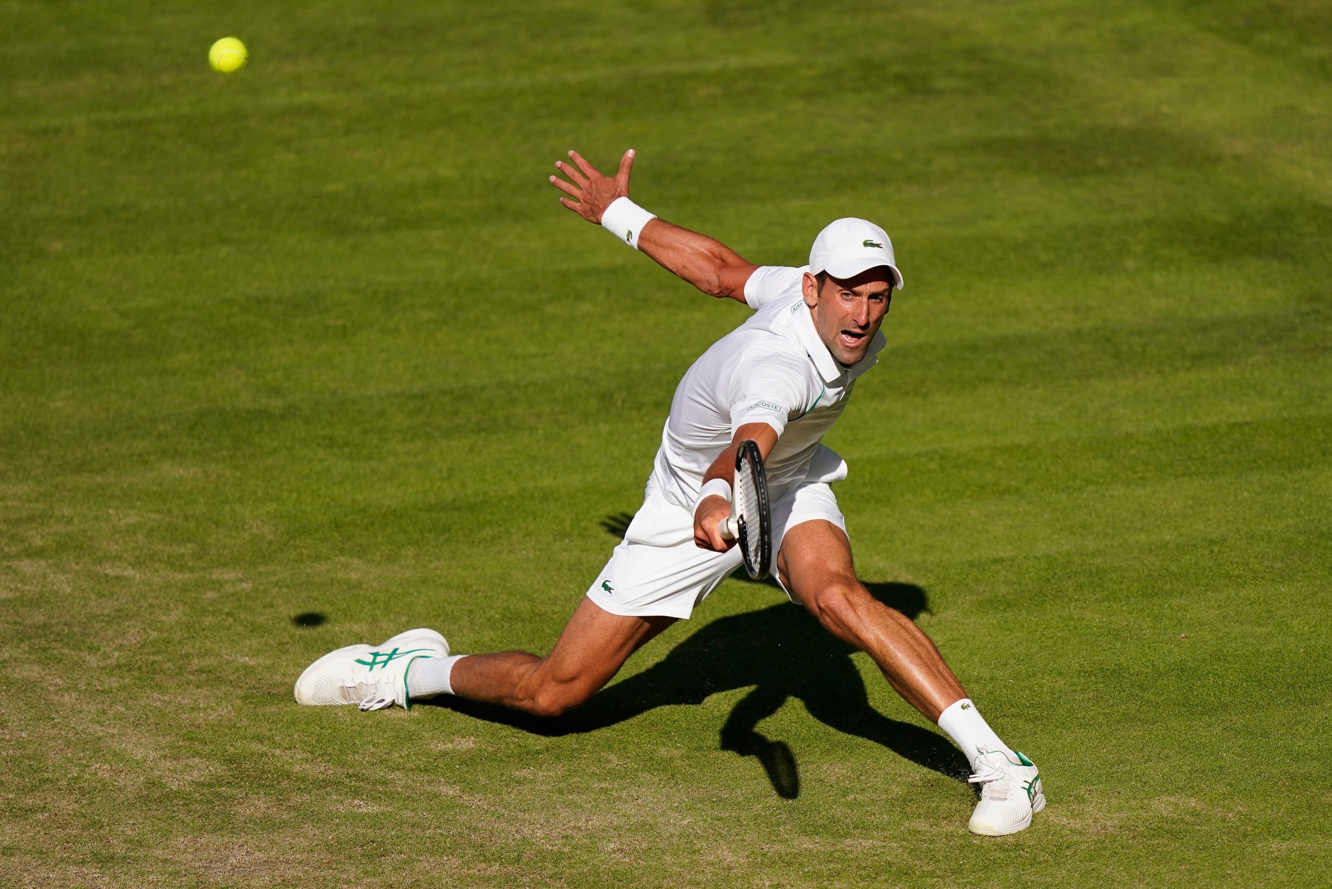 Serbia's Novak Djokovic returns to Britain's Cameron Norrie in a men's singles semifinal on day twelve of the Wimbledon tennis championships in London, Friday, July 8, 2022. (AP Photo/Gerald Herbert)