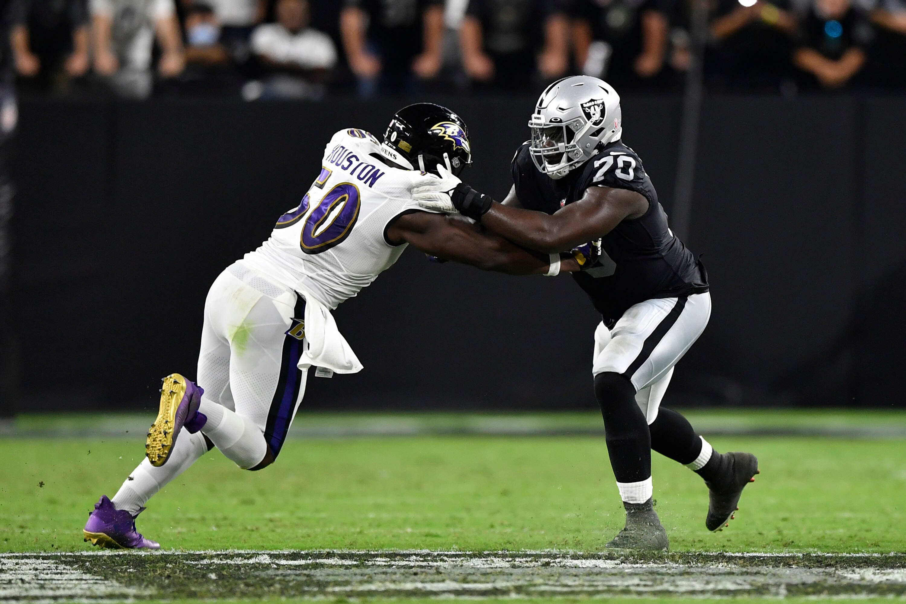 LAS VEGAS, NEVADA - SEPTEMBER 13: Offensive tackle Alex Leatherwood #70 of the Las Vegas Raiders blocks linebacker Justin Houston #50 of the Baltimore Ravens during a game at Allegiant Stadium on September 13, 2021 in Las Vegas, Nevada. The Raiders defeated the Ravens 33-27 in overtime. (Photo by Chris Unger/Getty Images) LAS VEGAS, NEVADA - SEPTEMBER 13: Offensive tackle Alex Leatherwood #70 of the Las Vegas Raiders blocks linebacker Justin Houston #50 of the Baltimore Ravens during a game at Allegiant Stadium on September 13, 2021 in Las Vegas, Nevada. The Raiders defeated the Ravens 33-27 in overtime. (Photo by Chris Unger/Getty Images)