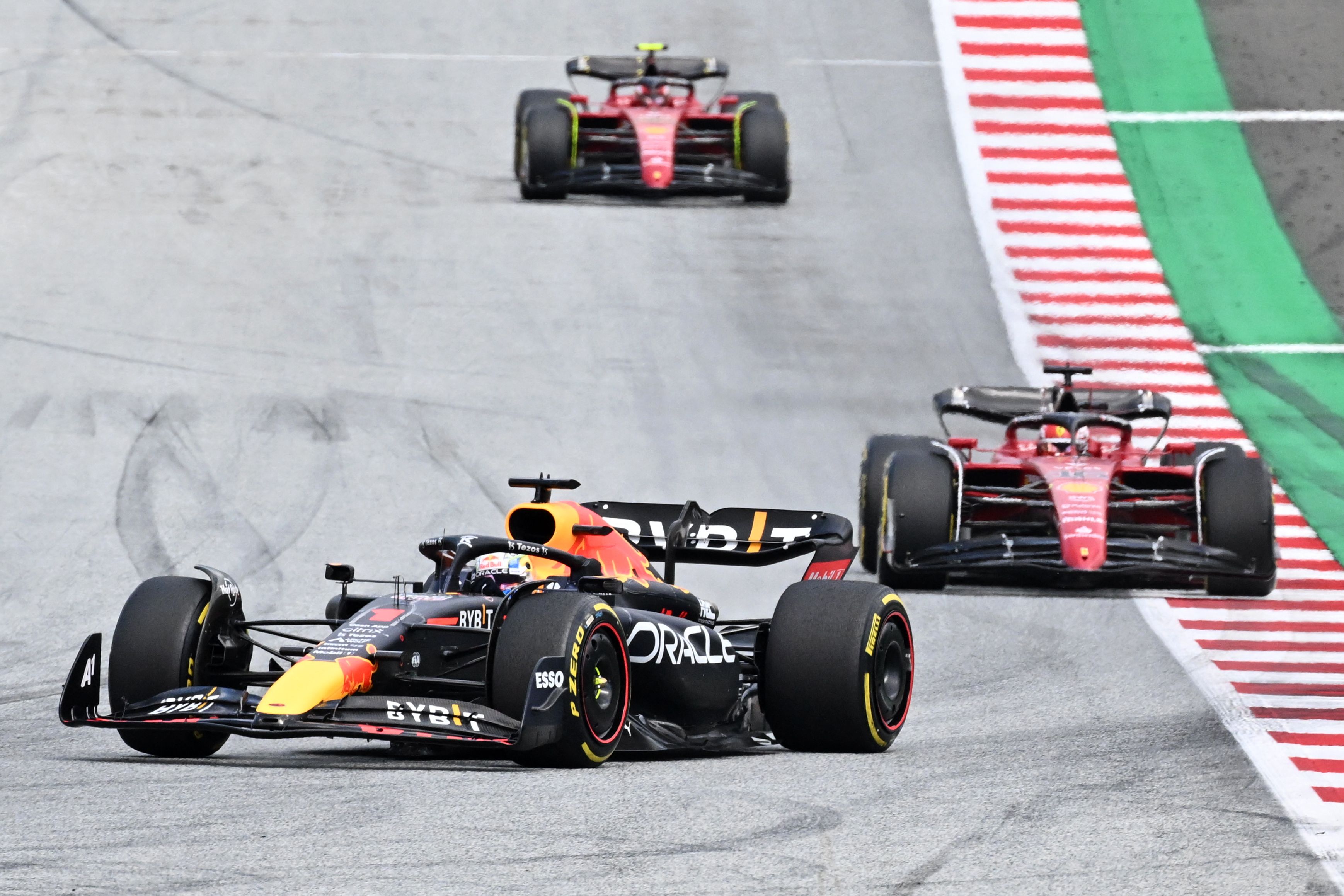 Red Bull Racing's Dutch driver Max Verstappen (front) takes the lead ahead of Ferrari's Monegasque driver Charles Leclerc and Ferrari's Spanish driver Carlos Sainz Jr after the start of the Formula One Austrian Grand Prix on the Red Bull Ring race track in Spielberg, Austria, on July 10, 2022. (Photo by Joe Klamar / AFP) (Photo by JOE KLAMAR/AFP via Getty Images)