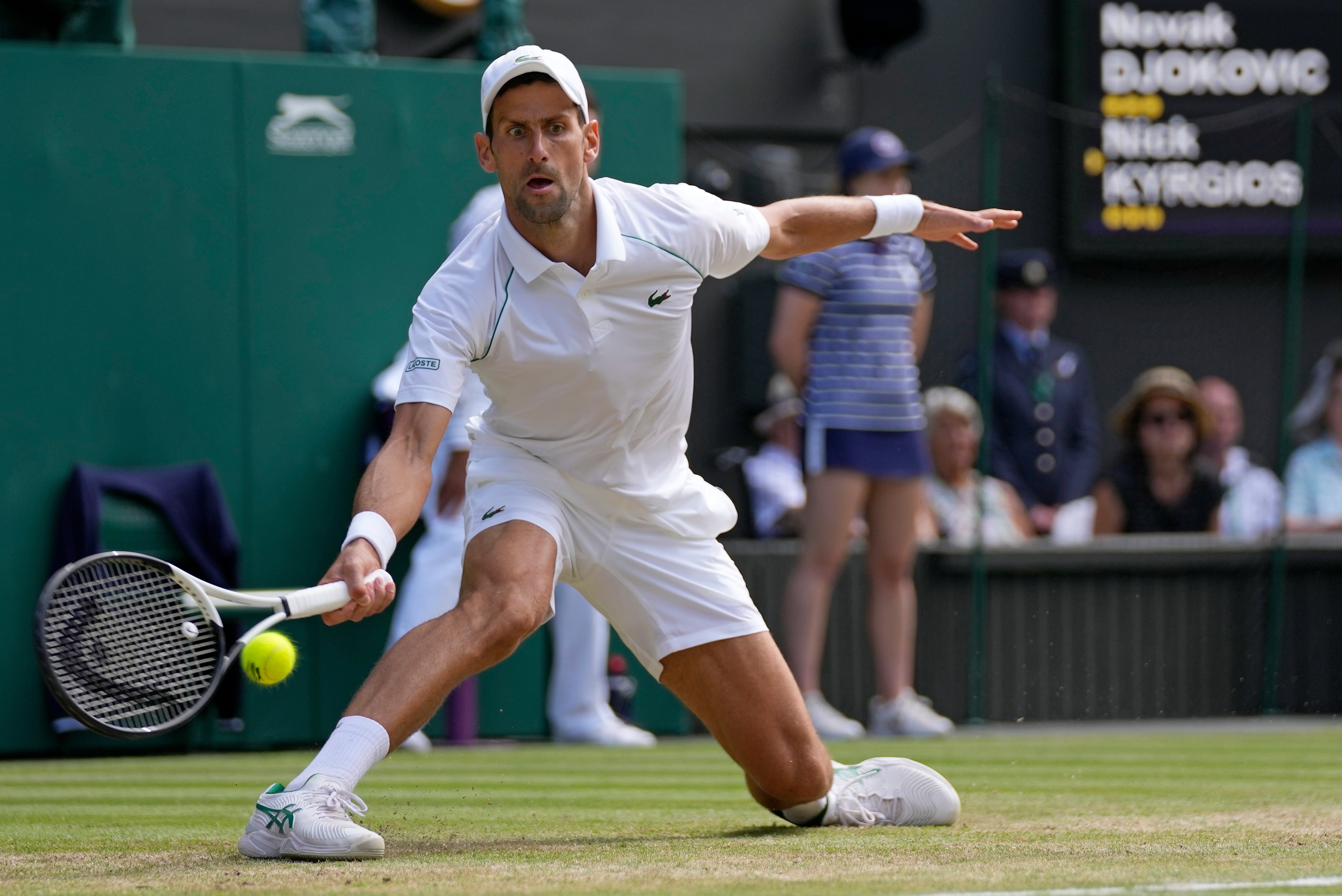 Serbia's Novak Djokovic returns to Australia's Nick Kyrgios in the final of the men's singles on day fourteen of the Wimbledon tennis championships in London, Sunday, July 10, 2022. (AP Photo/Alastair Grant)