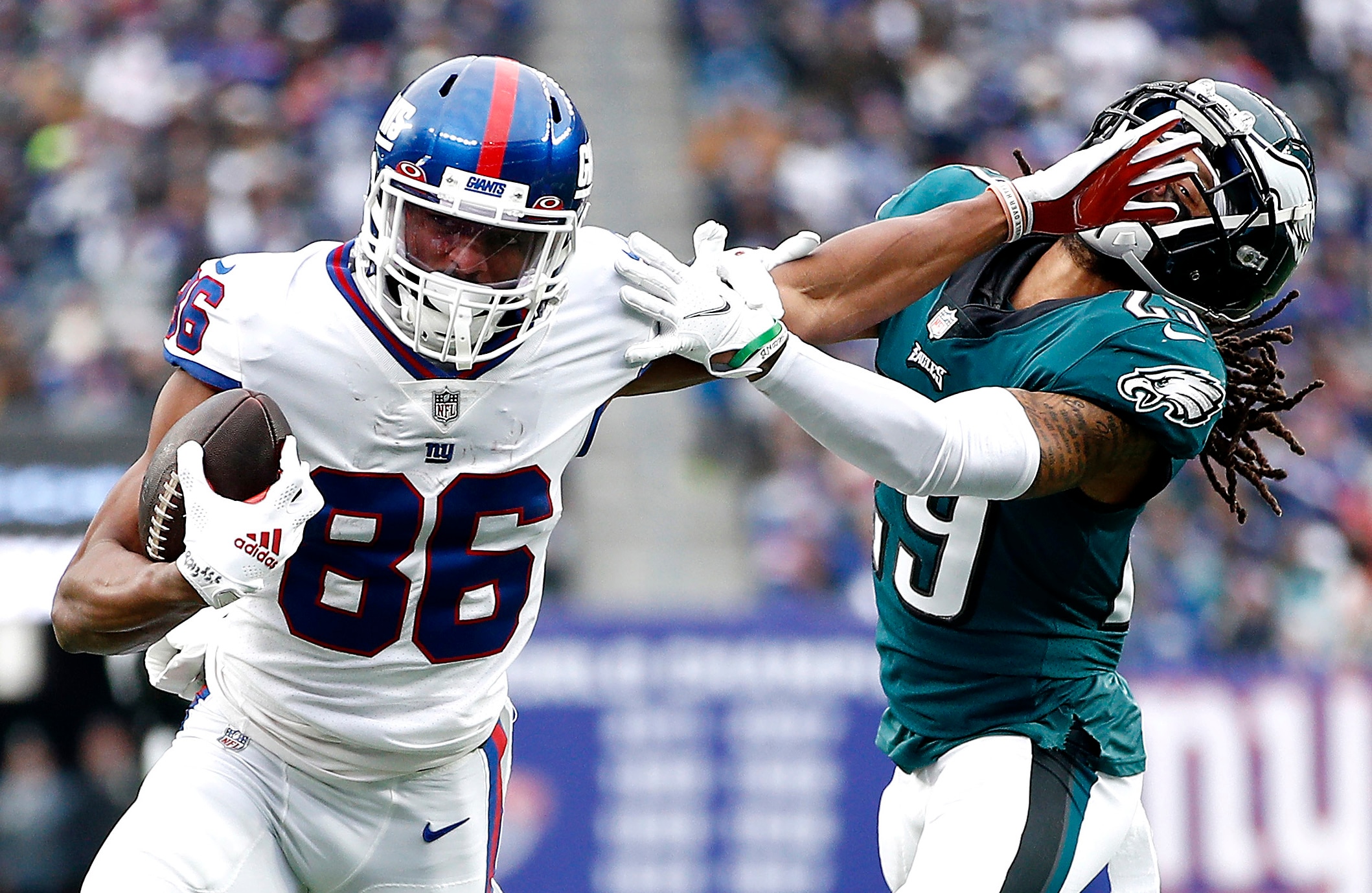 EAST RUTHERFORD, NEW JERSEY - NOVEMBER 28: Darius Slayton #86 of the New York Giants fends off a tackle attempt by Avonte Maddox #29 of the Philadelphia Eagles in the third quarter at MetLife Stadium on November 28, 2021 in East Rutherford, New Jersey. (Photo by Sarah Stier/Getty Images)
