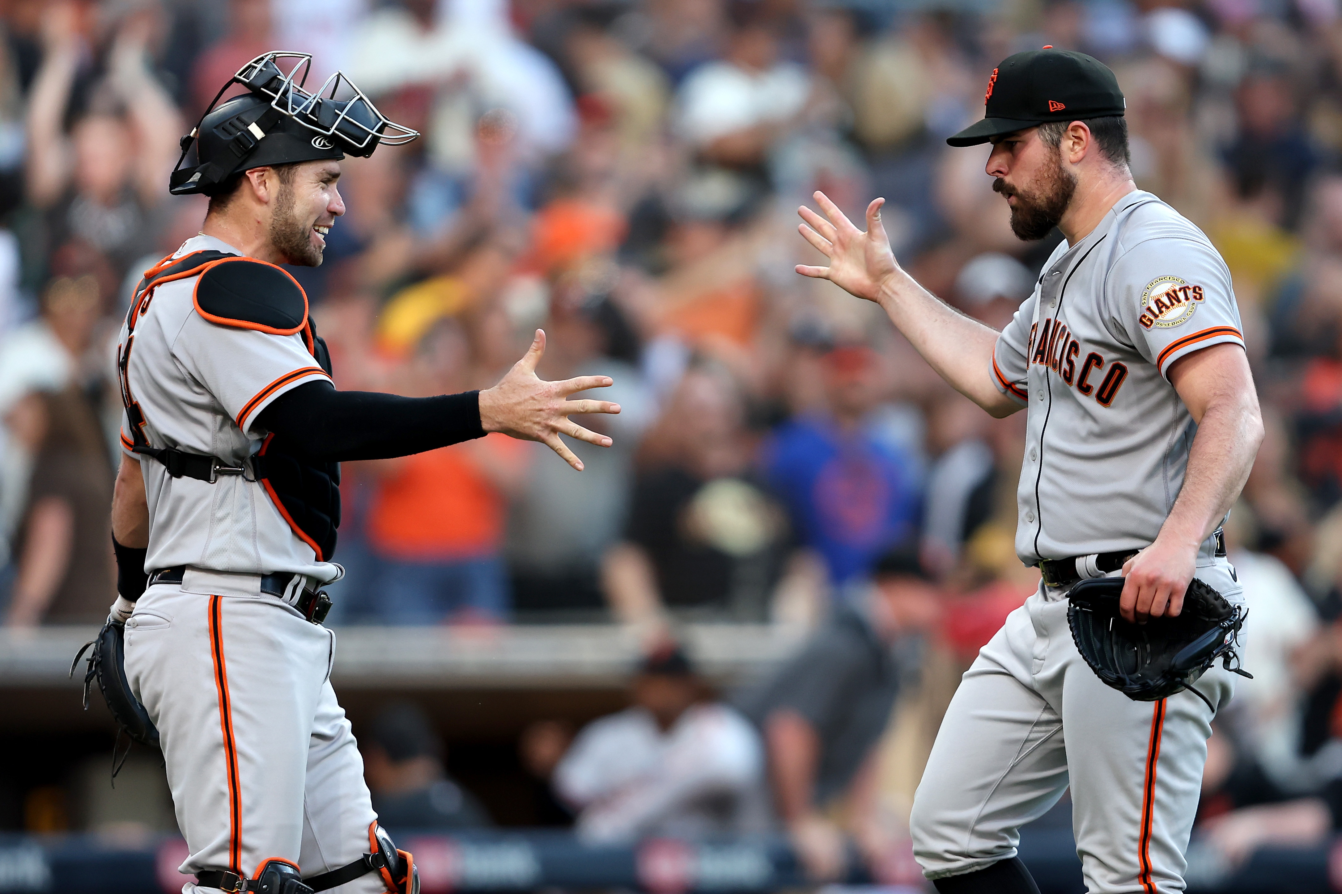 SAN DIEGO, CALIFORNIA - JULY 09: Austin Wynns #14 and Carlos Rodon #16 of the San Francisco Giants react after defeating the San Diego Padres 3-1 in a game at PETCO Park on July 09, 2022 in San Diego, California. (Photo by Sean M. Haffey/Getty Images)