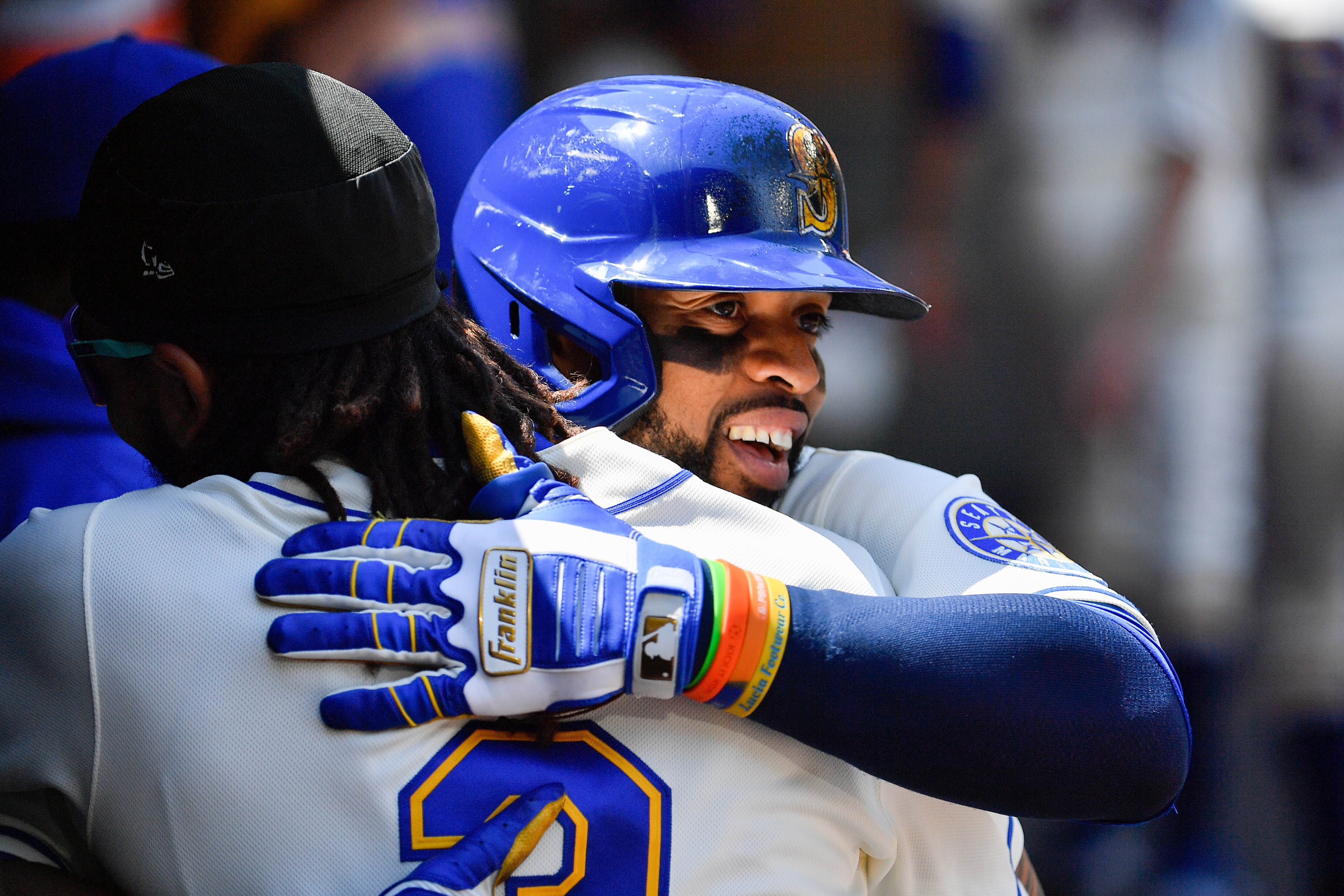 SEATTLE, WASHINGTON - JULY 10: Carlos Santana #41 of the Seattle Mariners and J.P. Crawford #3 hug after Santana's solo home run during the second inning against the Toronto Blue Jays at T-Mobile Park on July 10, 2022 in Seattle, Washington. (Photo by Alika Jenner/Getty Images)
