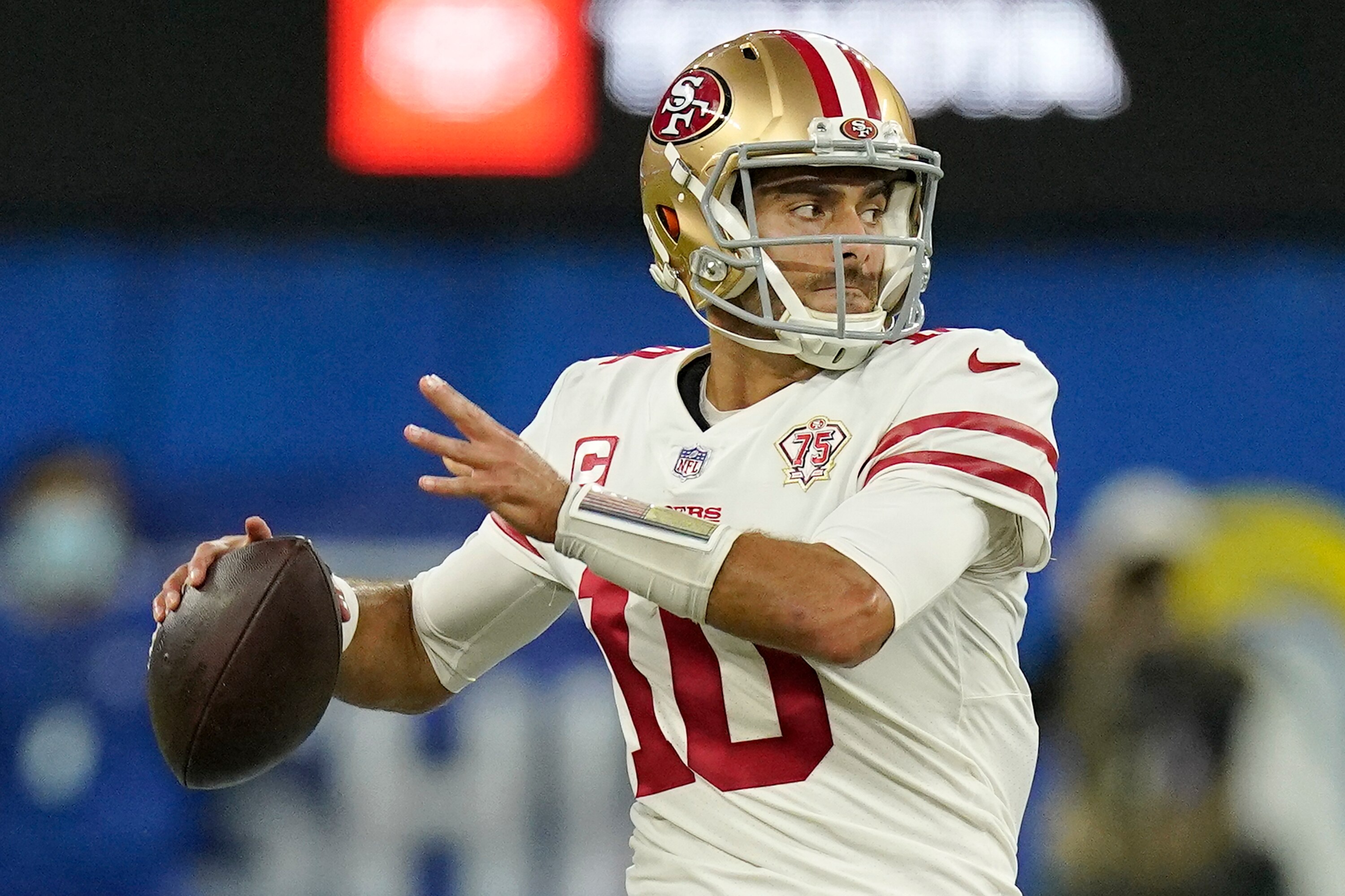 FILE - San Francisco 49ers' Jimmy Garoppolo looks to throw during the second half of the NFC Championship NFL football game against the Los Angeles Rams, Jan. 30, 2022, in Inglewood, Calif. Garoppolo expects his shoulder to be ready for training camp — wherever that may be. He told the AP Pro Football Podcast on Thursday, April 21, 2022, that his rehab is going well and it is helping him deal with uncertainty surrounding his future with the 49ers. (AP Photo/Mark J. Terrill, File)