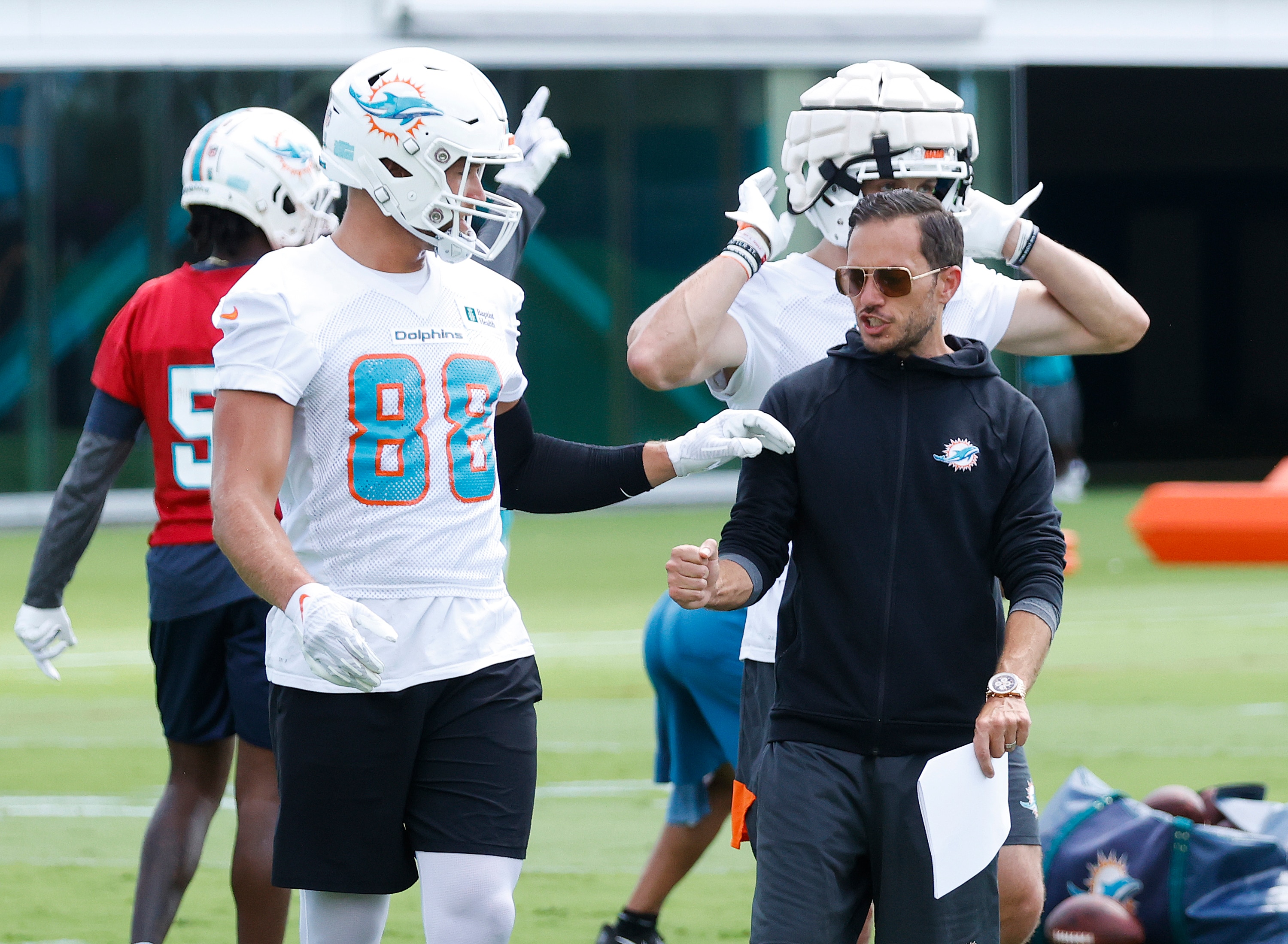 MIAMI GARDENS, FL - JUNE 1: Head coach Mike McDaniel talks to Mike Gesicki #88 of the Miami Dolphins during the Miami Dolphins Mandatory Minicamp at the Baptist Health Training Complex on June 1, 2022 in Miami Gardens, Florida. (Photo by Joel Auerbach/Getty Images)
