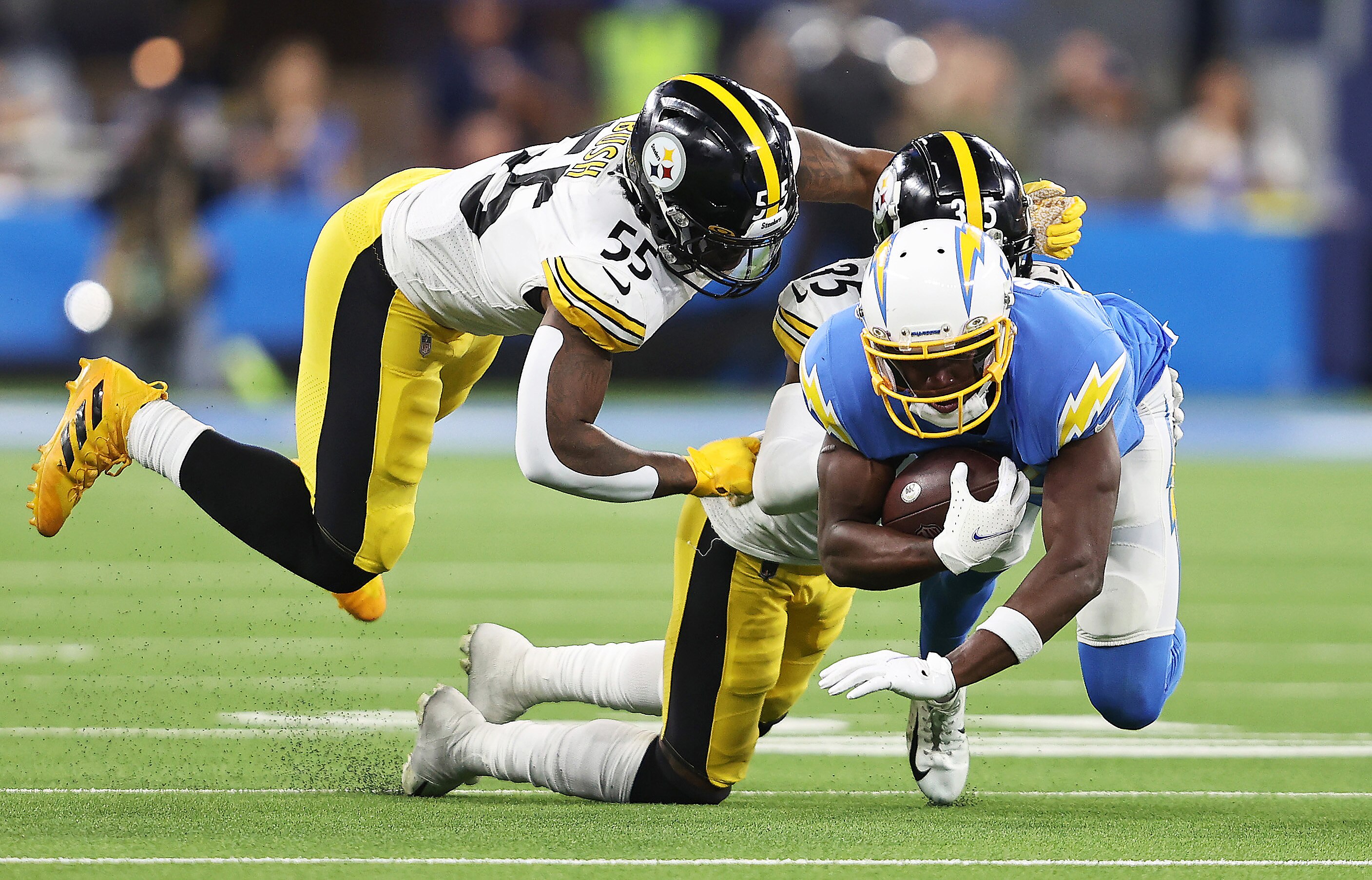 INGLEWOOD, CALIFORNIA - NOVEMBER 21: Josh Palmer #5 of the Los Angeles Chargers is tackled by Arthur Maulet #35 and Devin Bush #55 of the Pittsburgh Steelers during the third quarter at SoFi Stadium on November 21, 2021 in Inglewood, California. (Photo by Sean M. Haffey/Getty Images)
