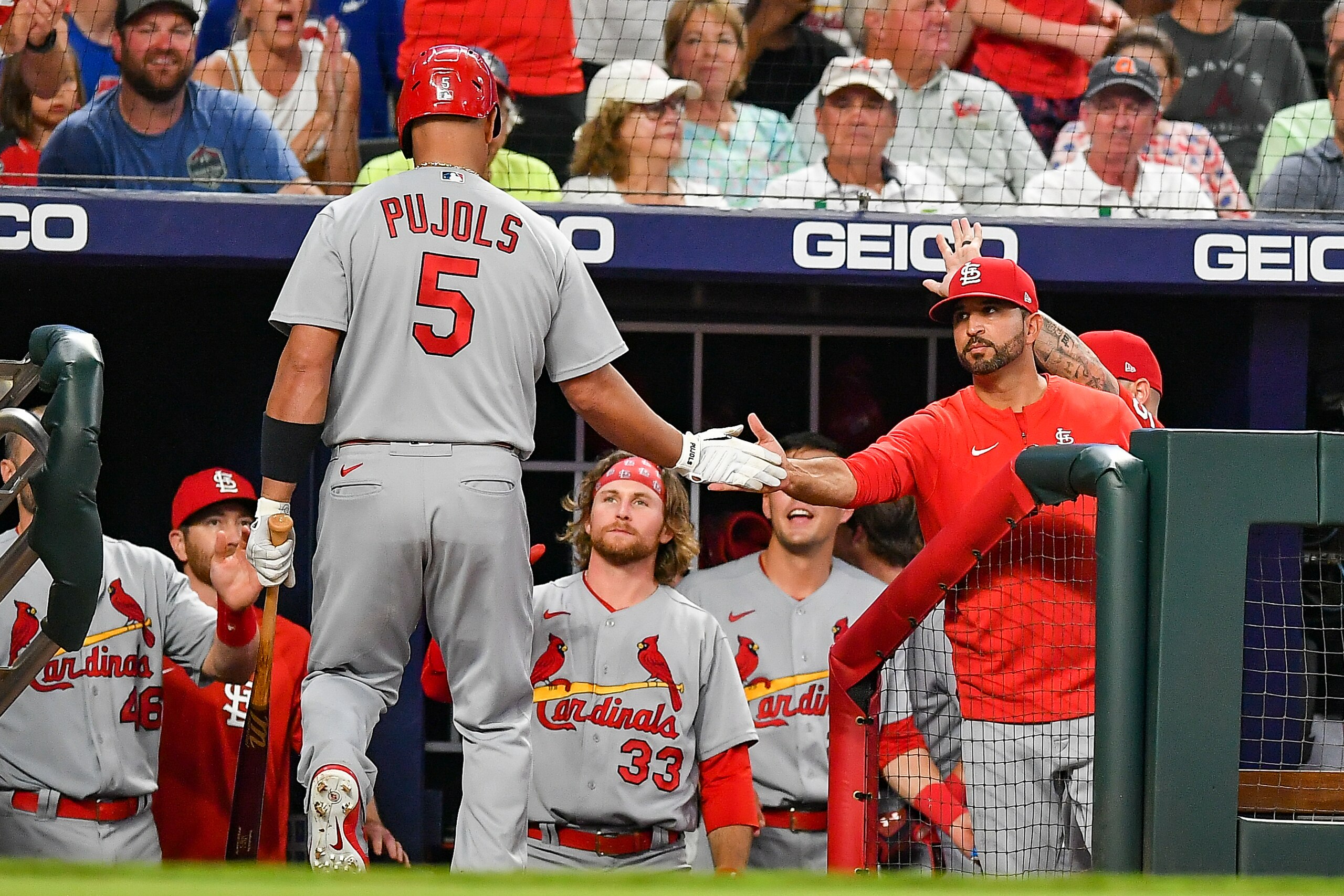 ATLANTA, GA  JULY 07:  St. Louis pinch hitter Albert Pujols (5) is congratulated by St. Louis manager Oliver Marmol (37) after driving in a run during the MLB game between the St. Louis Cardinals and the Atlanta Braves on July 7th, 2022 at Truist Park in Atlanta, GA. (Photo by Rich von Biberstein/Icon Sportswire via Getty Images)