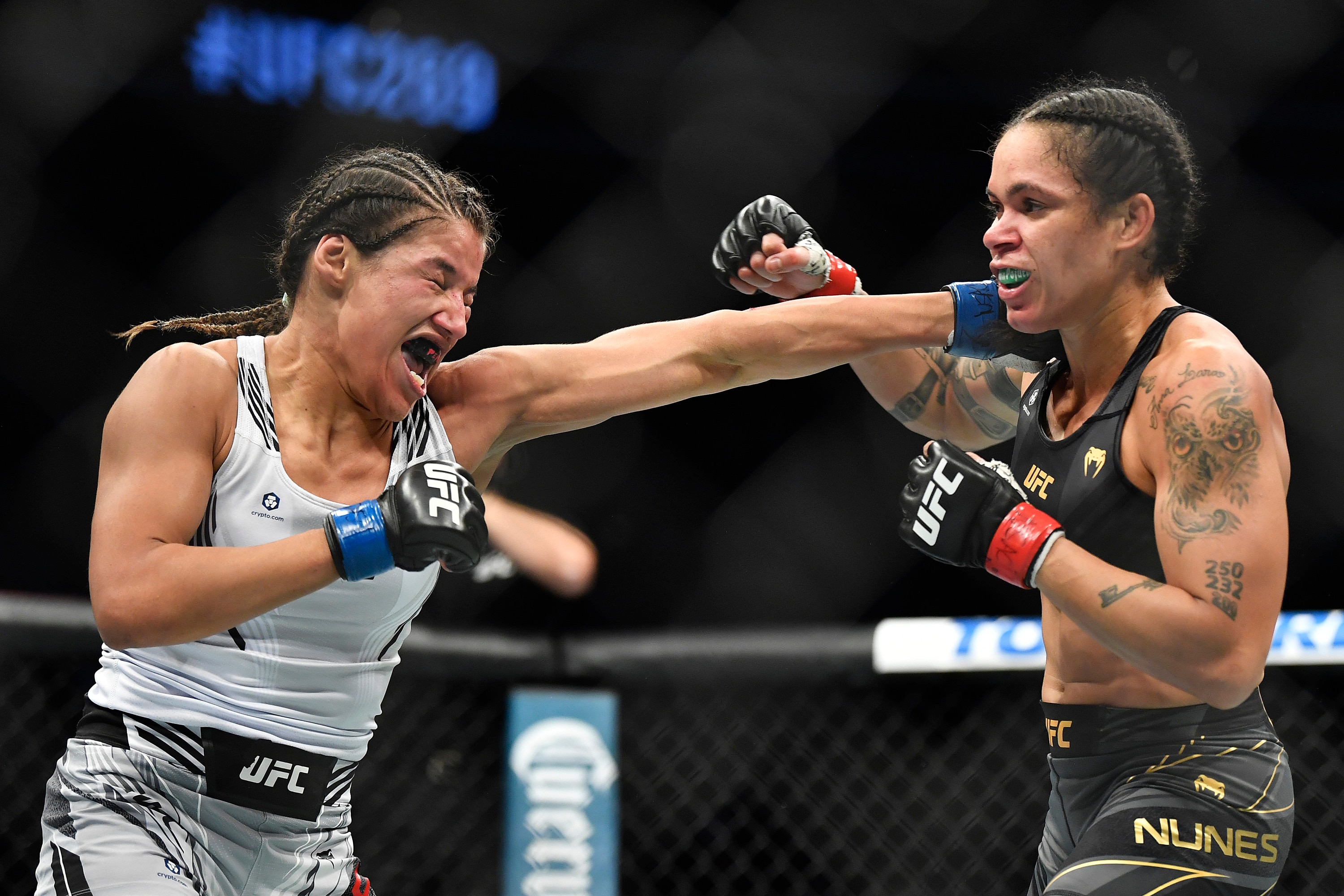 LAS VEGAS, NEVADA - DECEMBER 11: (L-R) Julianna Pena punches Amanda Nunes of Brazil in their UFC bantamweight championship bout during the UFC 269 on December 11, 2021 in Las Vegas, Nevada. (Photo by Chris Unger/Zuffa LLC)