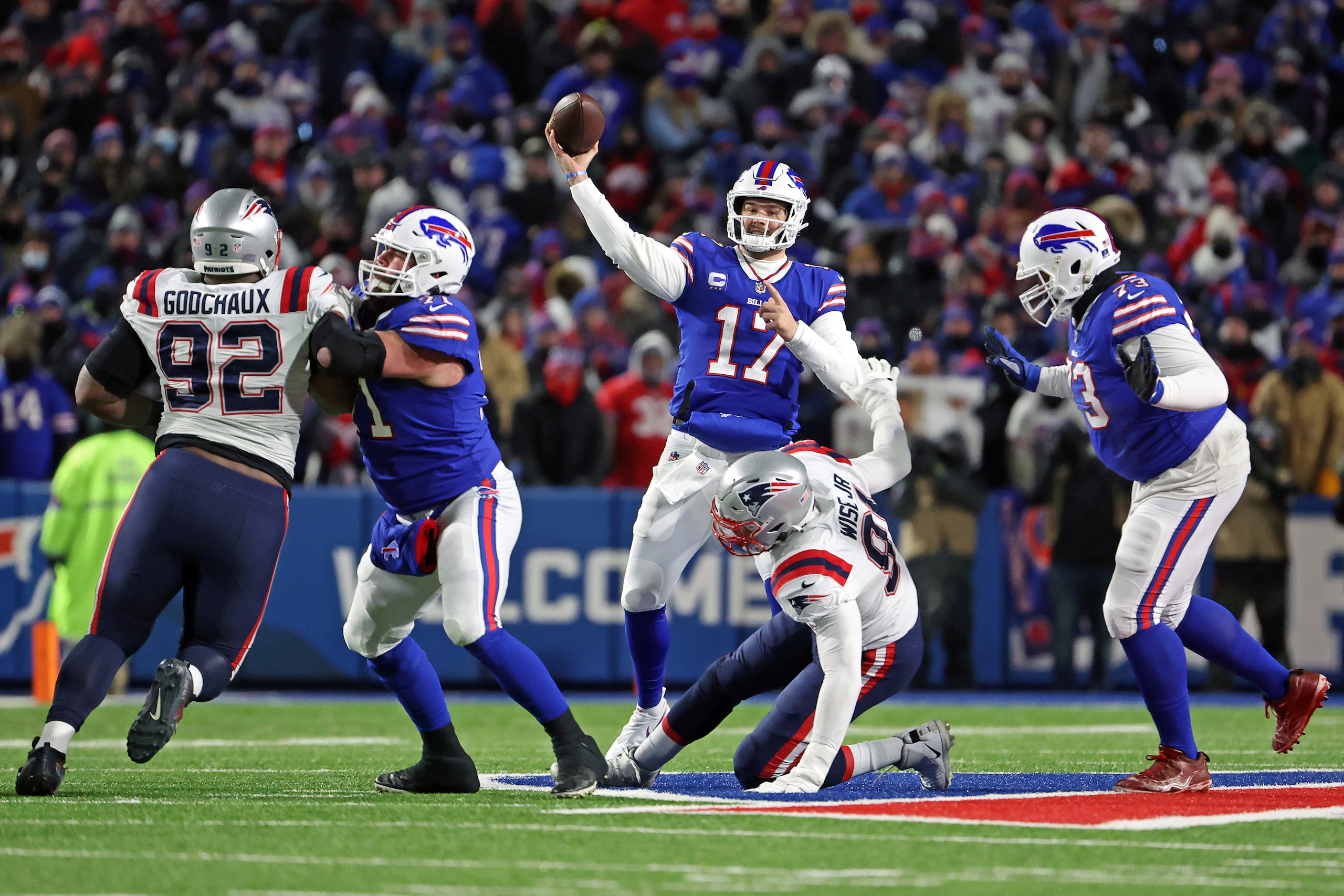 BUFFALO, NEW YORK - JANUARY 15: Josh Allen #17 of the Buffalo Bills throws a pass against the New England Patriots during the first half in the AFC Wild Card playoff game at Highmark Stadium on January 15, 2022 in Buffalo, New York. (Photo by Timothy T Ludwig/Getty Images)