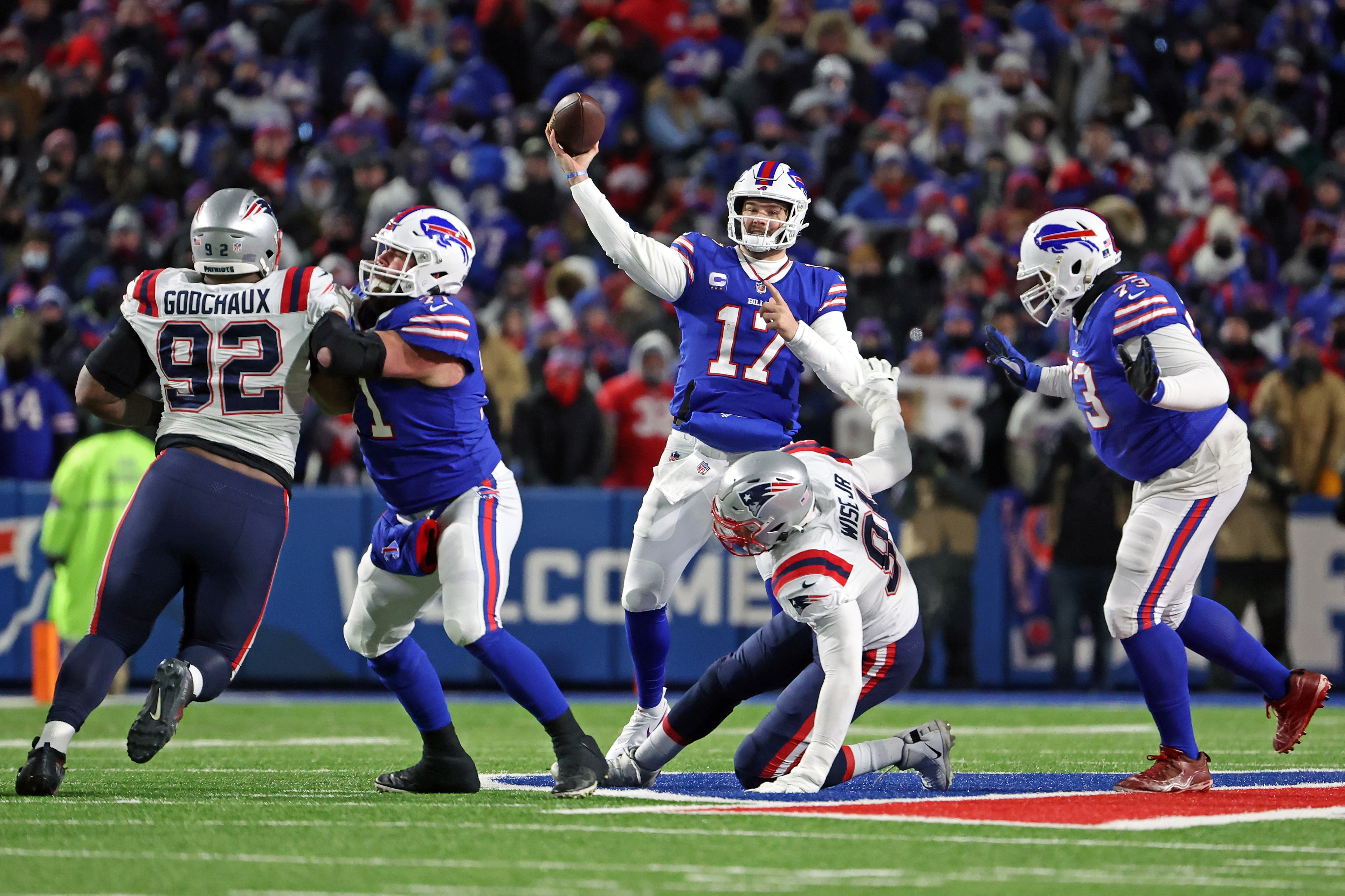 BUFFALO, NEW YORK - JANUARY 15: Josh Allen #17 of the Buffalo Bills throws a pass against the New England Patriots during the first half in the AFC Wild Card playoff game at Highmark Stadium on January 15, 2022 in Buffalo, New York. (Photo by Timothy T Ludwig/Getty Images)