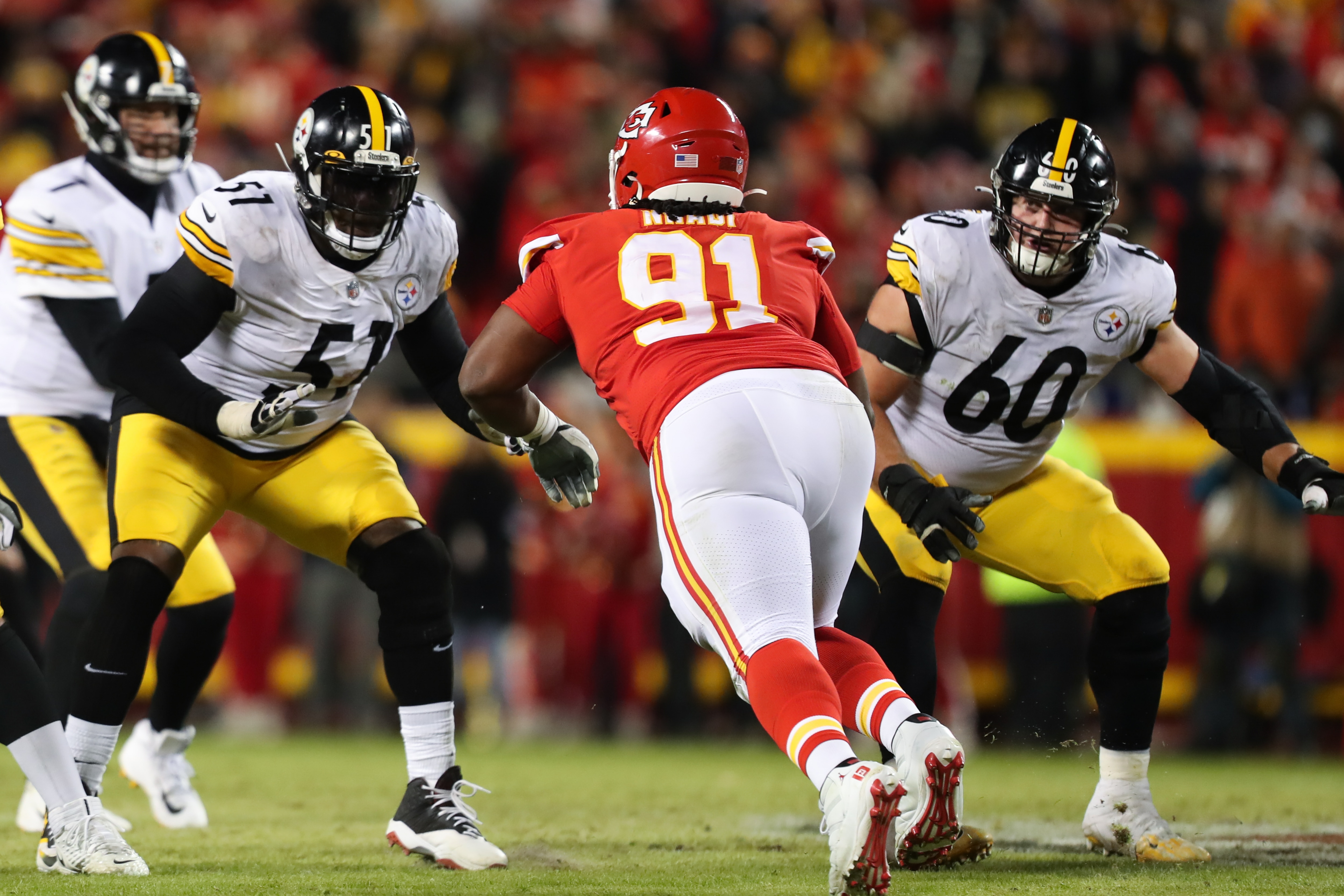 KANSAS CITY, MO - JANUARY 16: Pittsburgh Steelers guard Trai Turner (51) and center J.C. Hassenauer (60) look to block Kansas City Chiefs defensive tackle Derrick Nnadi (91) in the fourth quarter of an AFC wild card playoff game between the Pittsburgh Steelers and Kansas City Chiefs on Jan 16, 2022 at GEHA Field at Arrowhead Stadium in Kansas City, MO. (Photo by Scott Winters/Icon Sportswire via Getty Images)
