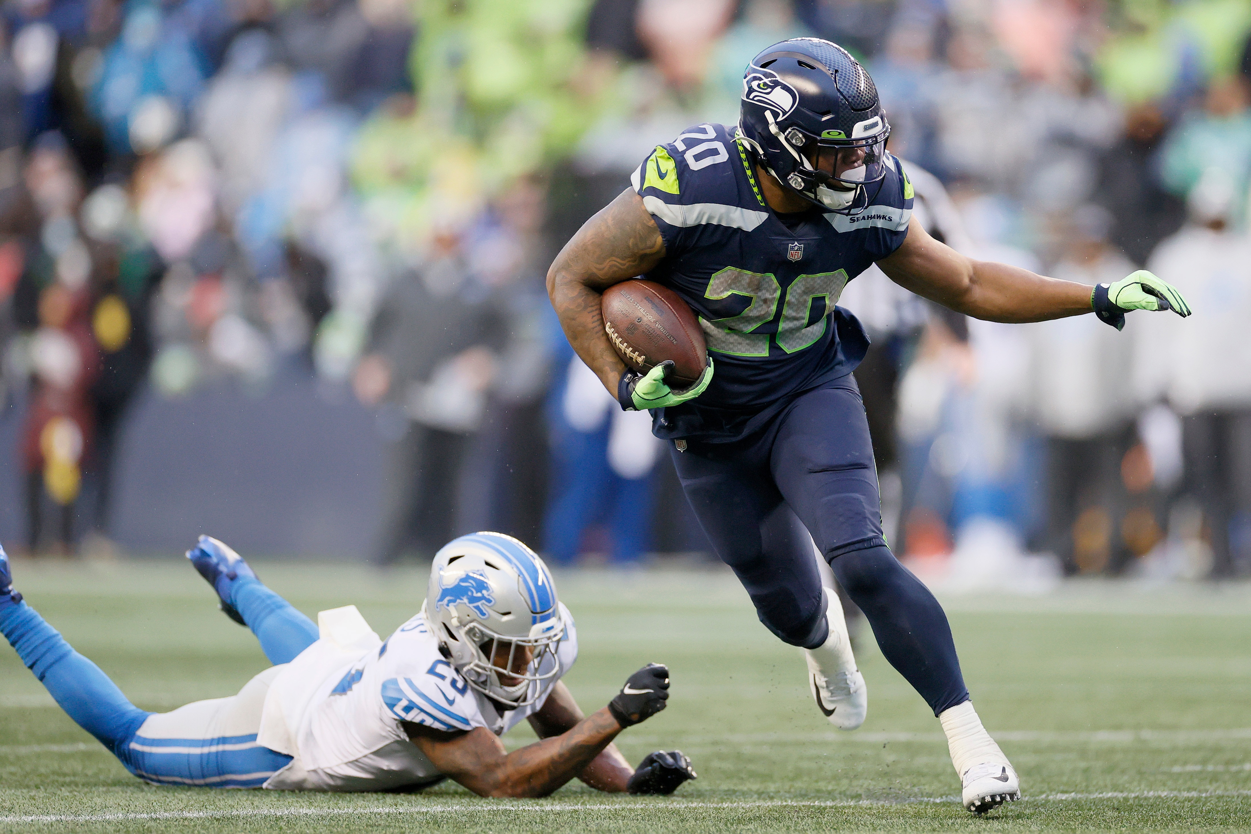 SEATTLE, WASHINGTON - JANUARY 02: Rashaad Penny #20 of the Seattle Seahawks carries the ball against the Detroit Lions during the third quarter at Lumen Field on January 02, 2022 in Seattle, Washington. (Photo by Steph Chambers/Getty Images)