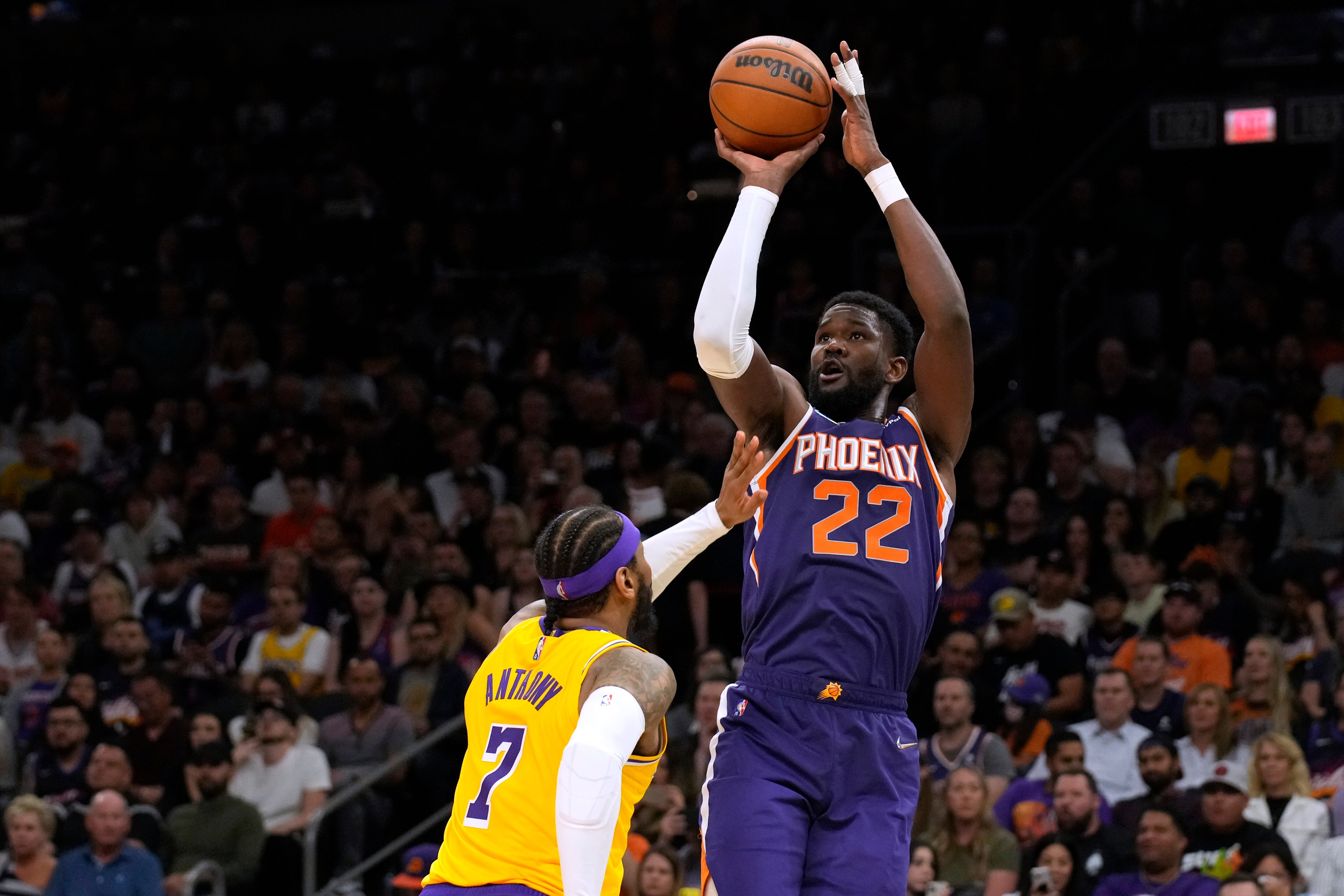 Phoenix Suns center Deandre Ayton shoots over Los Angeles Lakers forward Carmelo Anthony (7) during the second half of an NBA basketball game Tuesday, April 5, 2022, in Phoenix. The Suns won 121-110. (AP Photo/Rick Scuteri)