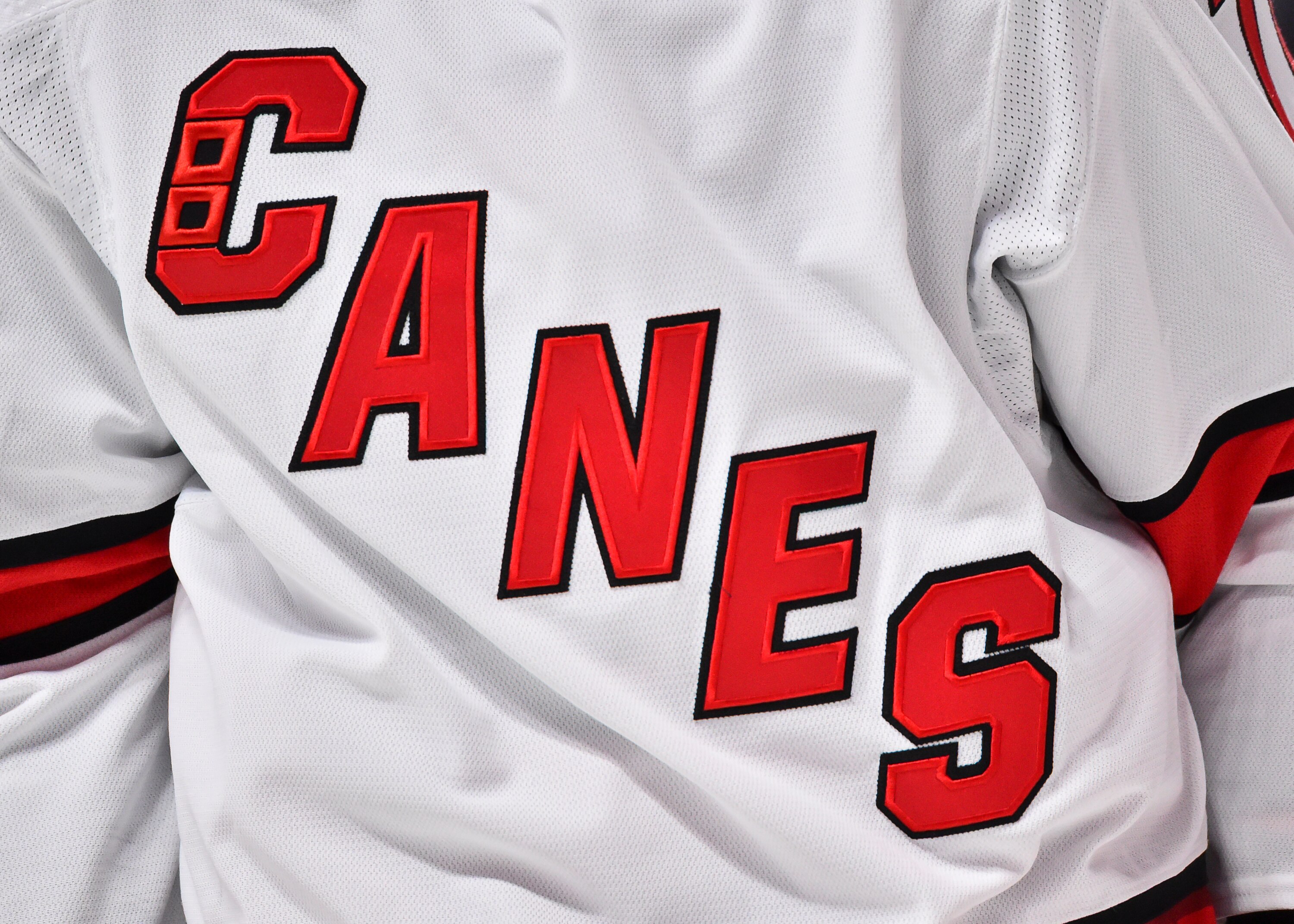 MONTREAL, QC - OCTOBER 21:  A detailed view of the Carolina Hurricanes logo during the second period in a game against the Montreal Canadiens at Centre Bell on October 21, 2021 in Montreal, Canada.  The Carolina Hurricanes defeated the Montreal Canadiens 4-1.  (Photo by Minas Panagiotakis/Getty Images)