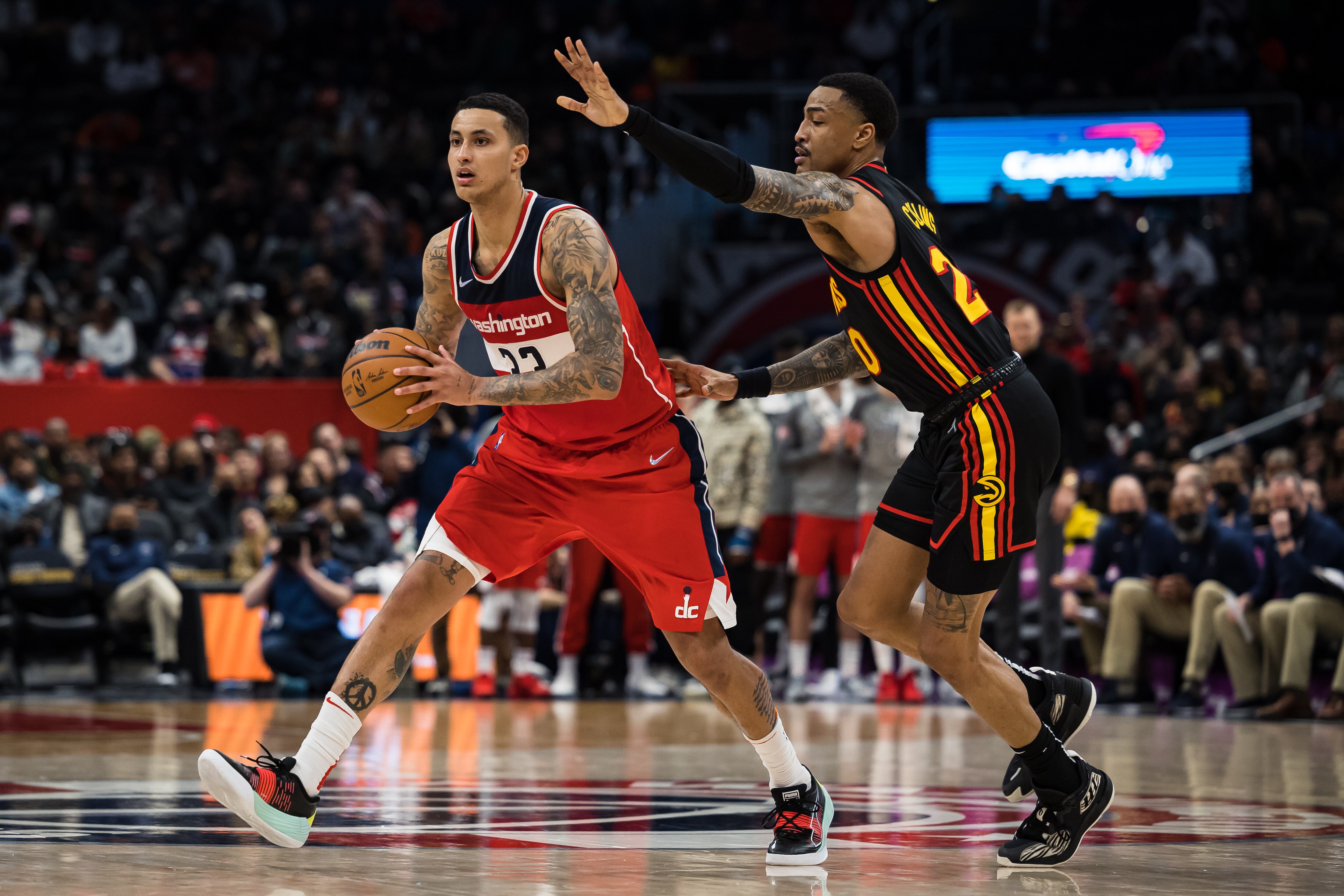 WASHINGTON, DC - MARCH 04: Kyle Kuzma #33 of the Washington Wizards in action against John Collins #20 of the Atlanta Hawks during the second half at Capital One Arena on March 4, 2022 in Washington, DC. NOTE TO USER: User expressly acknowledges and agrees that, by downloading and or using this photograph, User is consenting to the terms and conditions of the Getty Images License Agreement. (Photo by Scott Taetsch/Getty Images)