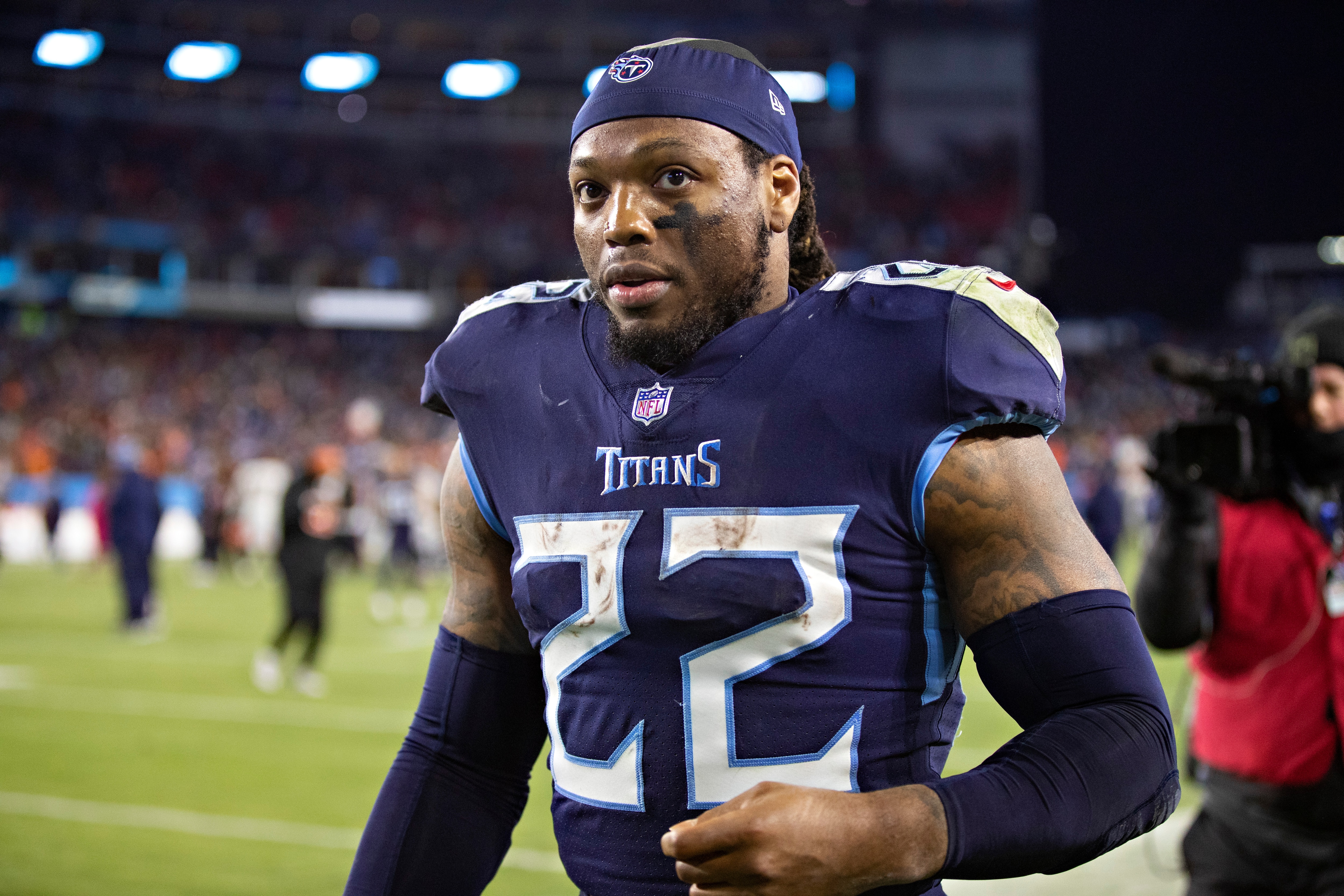 NASHVILLE, TENNESSEE - JANUARY 22: Derrick Henry #22 of the Tennessee Titans walks off the field after a game against the Cincinnati Bengals in the AFC Divisional Playoff game at Nissan Stadium on January 22, 2022 in Nashville, Tennessee. The Bengals defeated the Titans 19-16.  (Photo by Wesley Hitt/Getty Images)