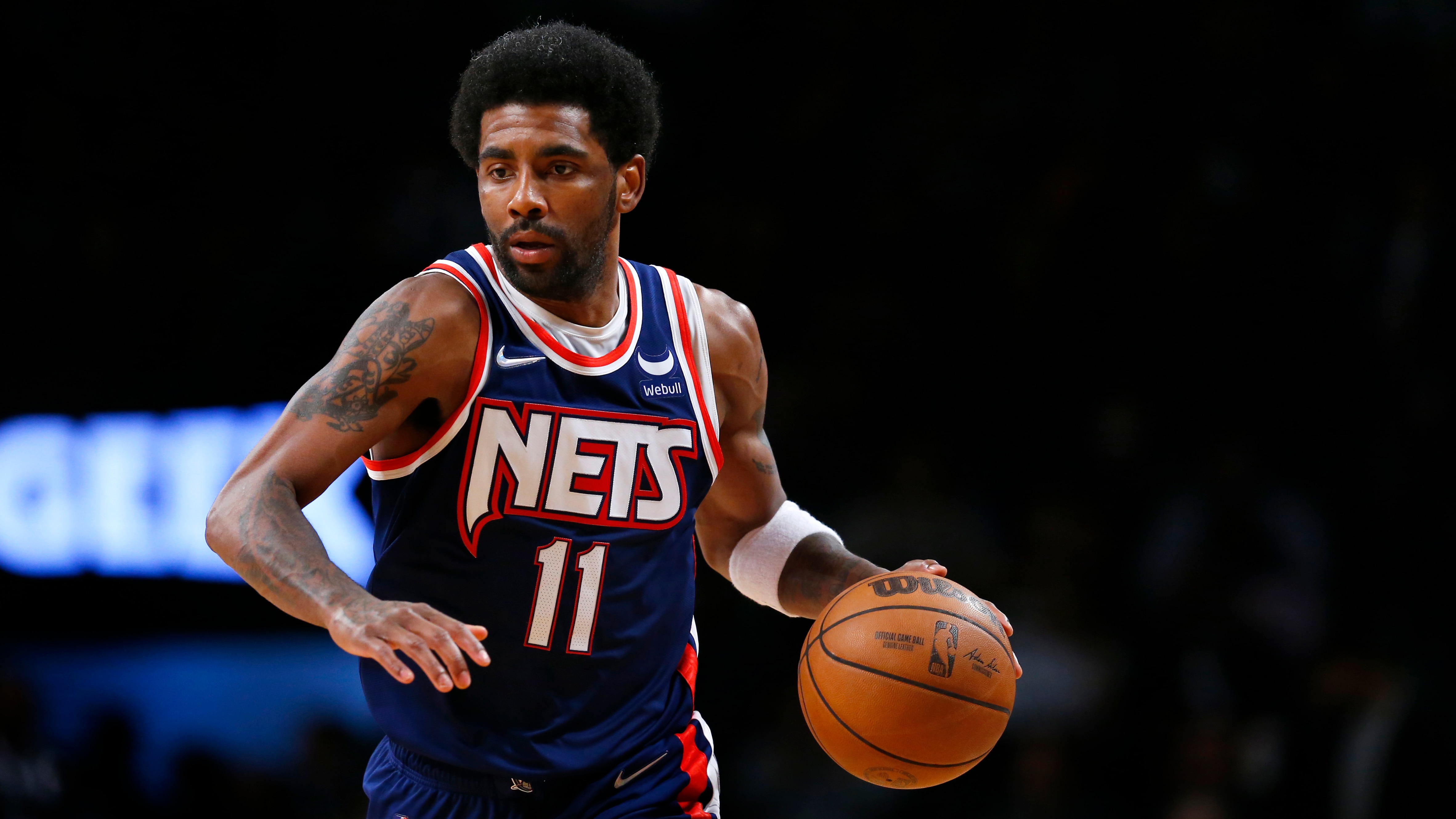 Brooklyn Nets guard Kyrie Irving (11) dribbles the ball against the Milwaukee Bucks during the second half of an NBA basketball game, Thursday, March 31, 2022 in New York. The Milwaukee Bucks won 120-119 in overtime. (AP Photo/Noah K. Murray)