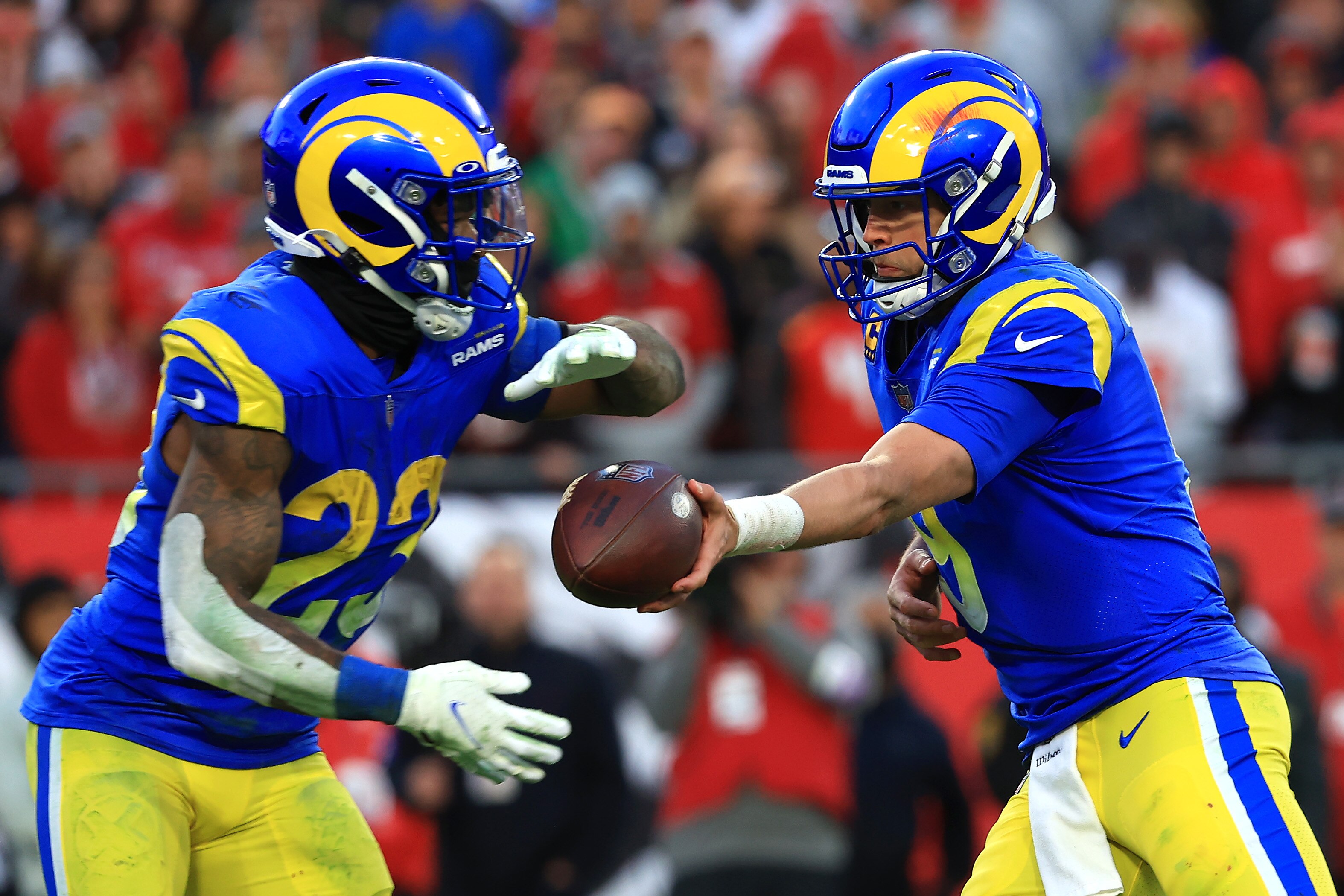 TAMPA, FLORIDA - JANUARY 23: Matthew Stafford #9 of the Los Angeles Rams hands the ball off to teammate Cam Akers #23in the fourth quarter of the game against the Tampa Bay Buccaneers in the NFC Divisional Playoff game at Raymond James Stadium on January 23, 2022 in Tampa, Florida. (Photo by Mike Ehrmann/Getty Images)