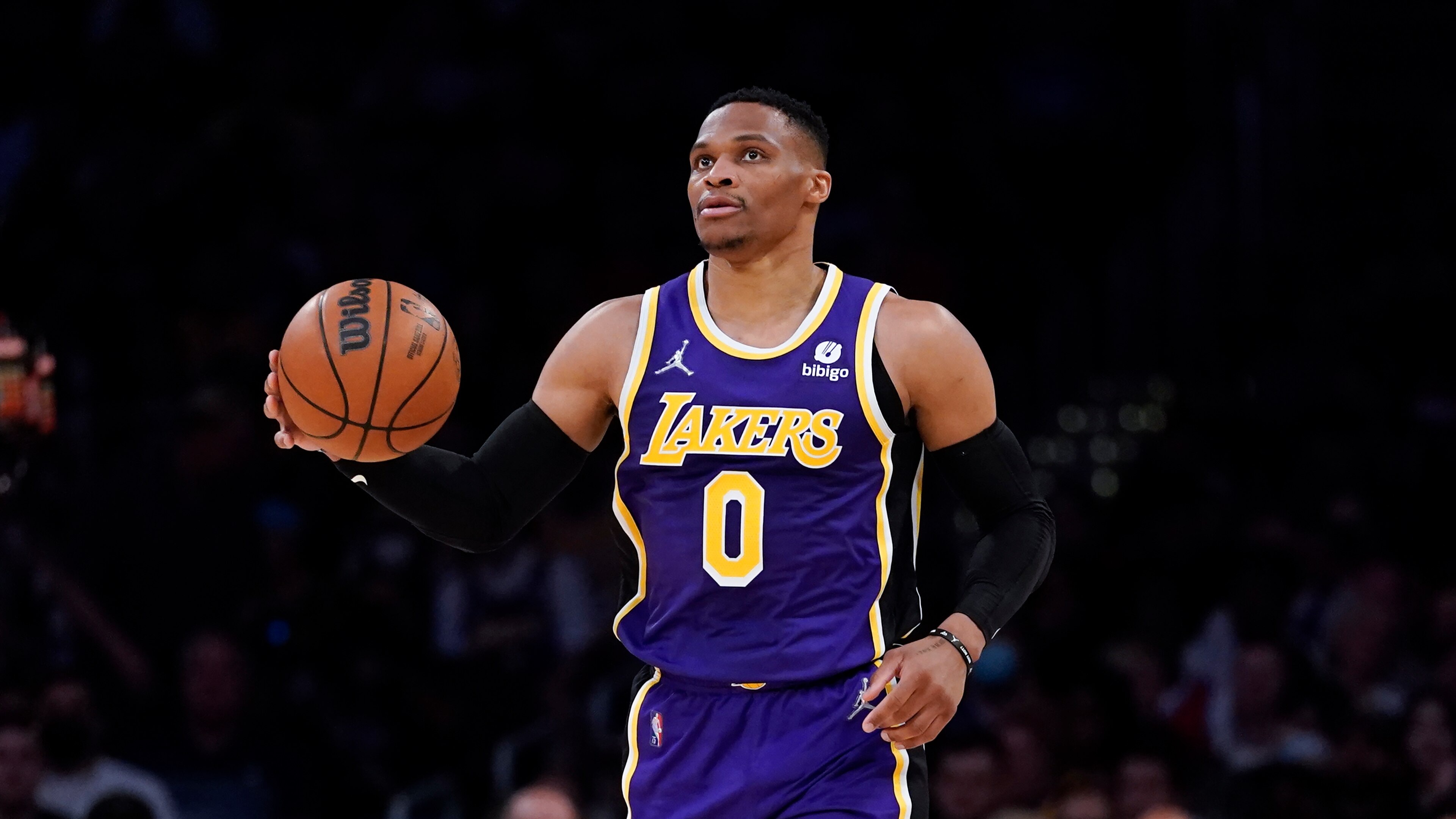 Los Angeles Lakers guard Russell Westbrook (0) controls the ball during an NBA basketball game against the Philadelphia 76ers in Los Angeles, Wednesday, March 23, 2022. (AP Photo/Ashley Landis)
