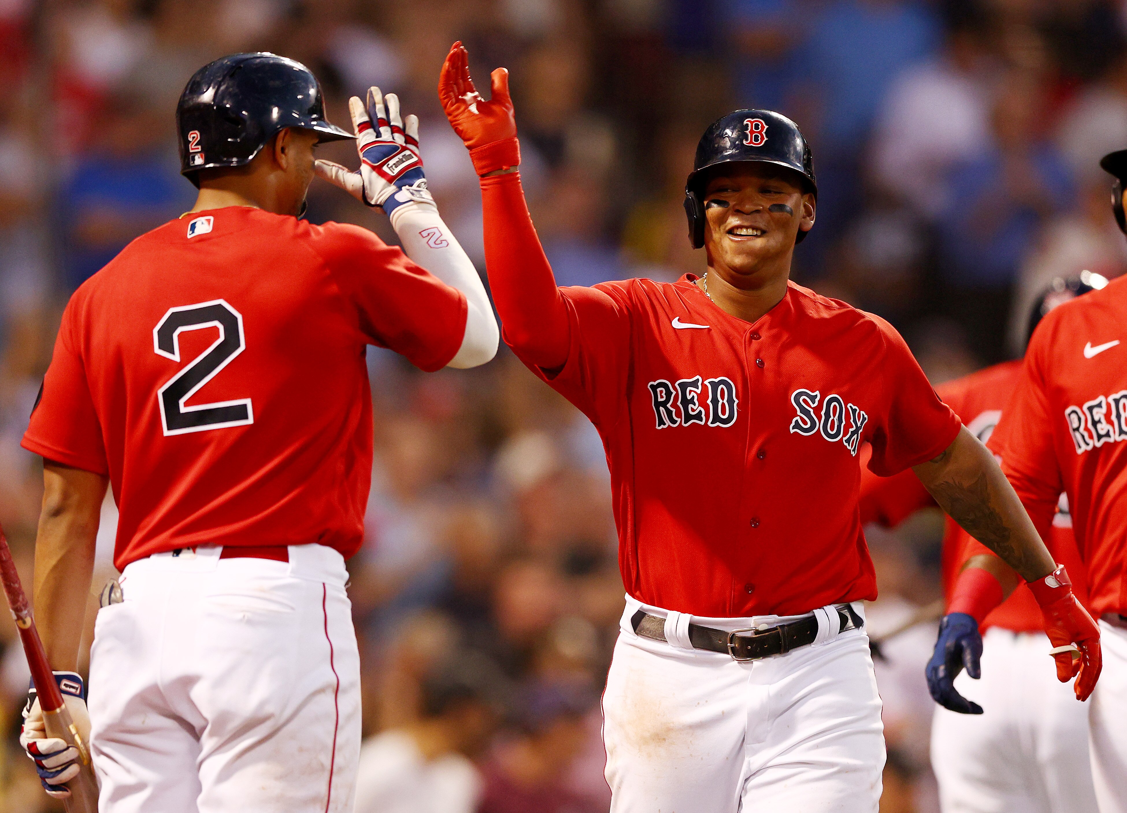 BOSTON, MASSACHUSETTS - JUNE 14:  Rafael Devers #11 of the Boston Red Sox celebrates his three run home run with teammate Xander Bogaerts in the fourth inning against the Oakland Athletics at Fenway Park on June 14, 2022 in Boston, Massachusetts. (Photo by Elsa/Getty Images)