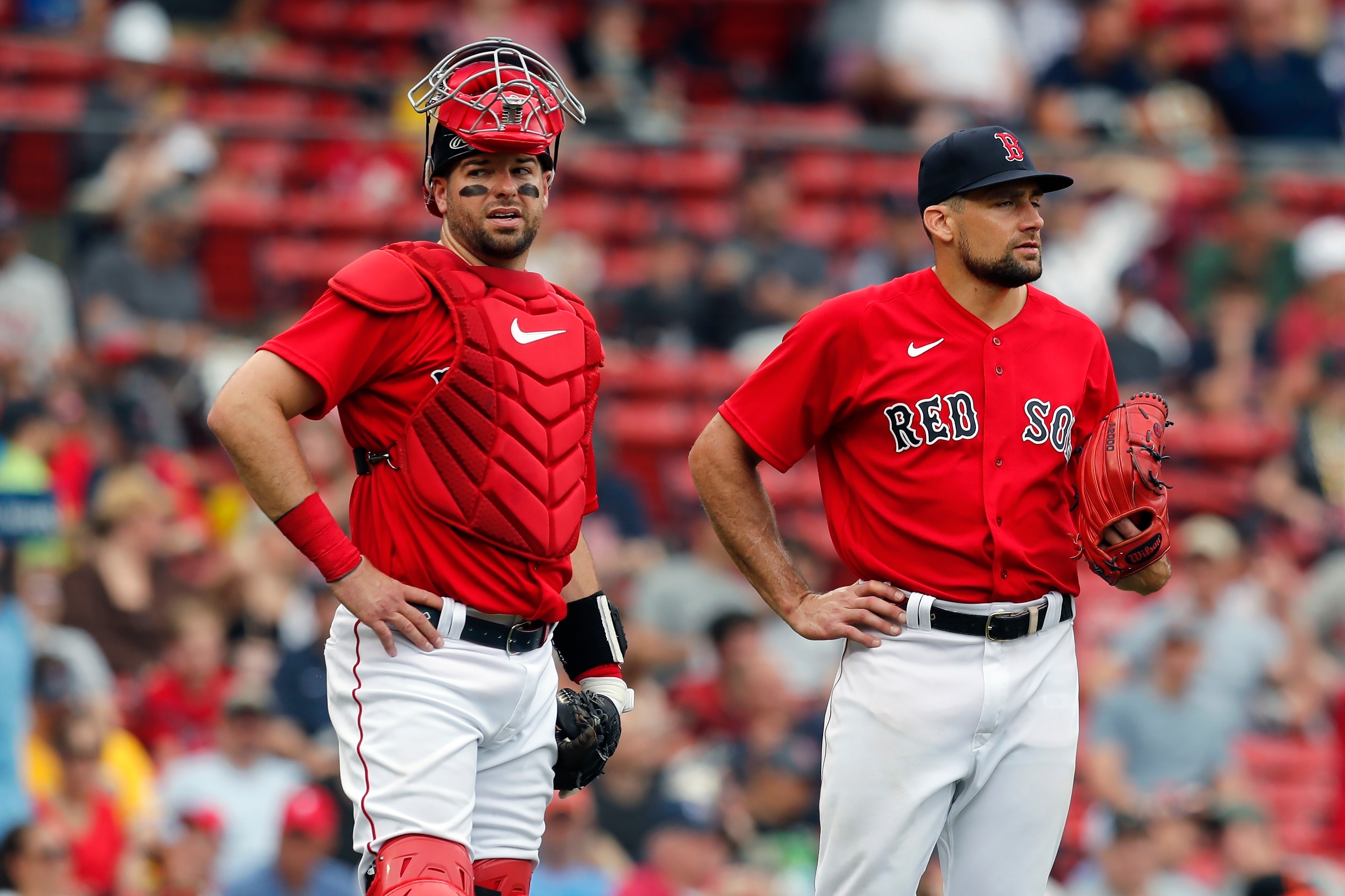 Boston Red Sox's Kevin Plawecki, left, Nathan Eovaldi wait for a play challenge during the first inning of the first game of a baseball doubleheader against the Baltimore Orioles, Saturday, May 28, 2022, in Boston. (AP Photo/Michael Dwyer)