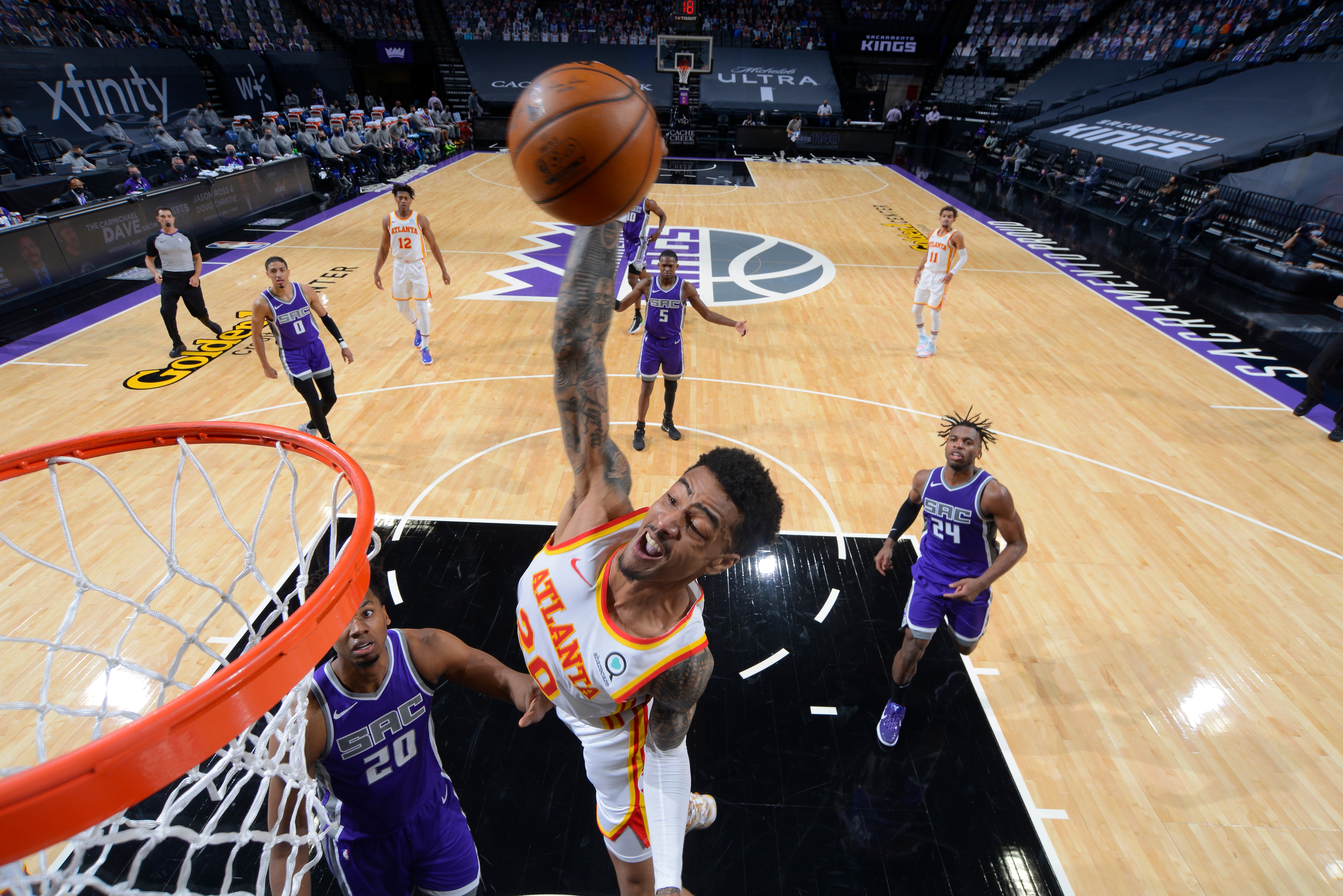 SACRAMENTO, CA - MARCH 24: John Collins #20 of the Atlanta Hawks dunks the ball against the Sacramento Kings on March 24, 2021 at Golden 1 Center in Sacramento, California. NOTE TO USER: User expressly acknowledges and agrees that, by downloading and or using this Photograph, user is consenting to the terms and conditions of the Getty Images License Agreement. Mandatory Copyright Notice: Copyright 2021 NBAE (Photo by Rocky Widner/NBAE via Getty Images)