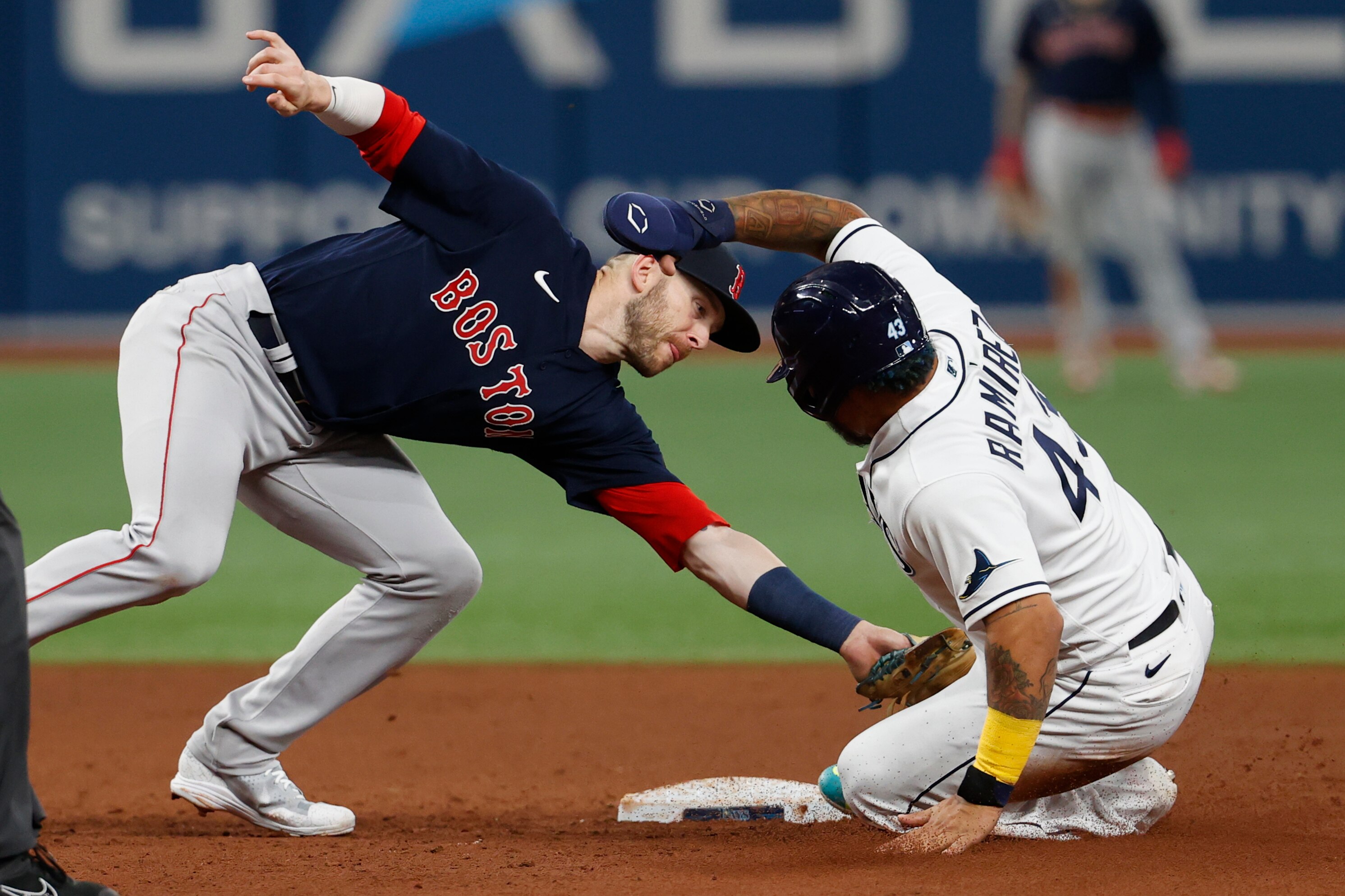 Tampa Bay Rays' Harold Ramirez, right, is tagged out by Boston Red Sox second baseman Trevor Story on a steal-attempt during the sixth inning of a baseball game Monday, July 11, 2022, in St. Petersburg, Fla. (AP Photo/Scott Audette)