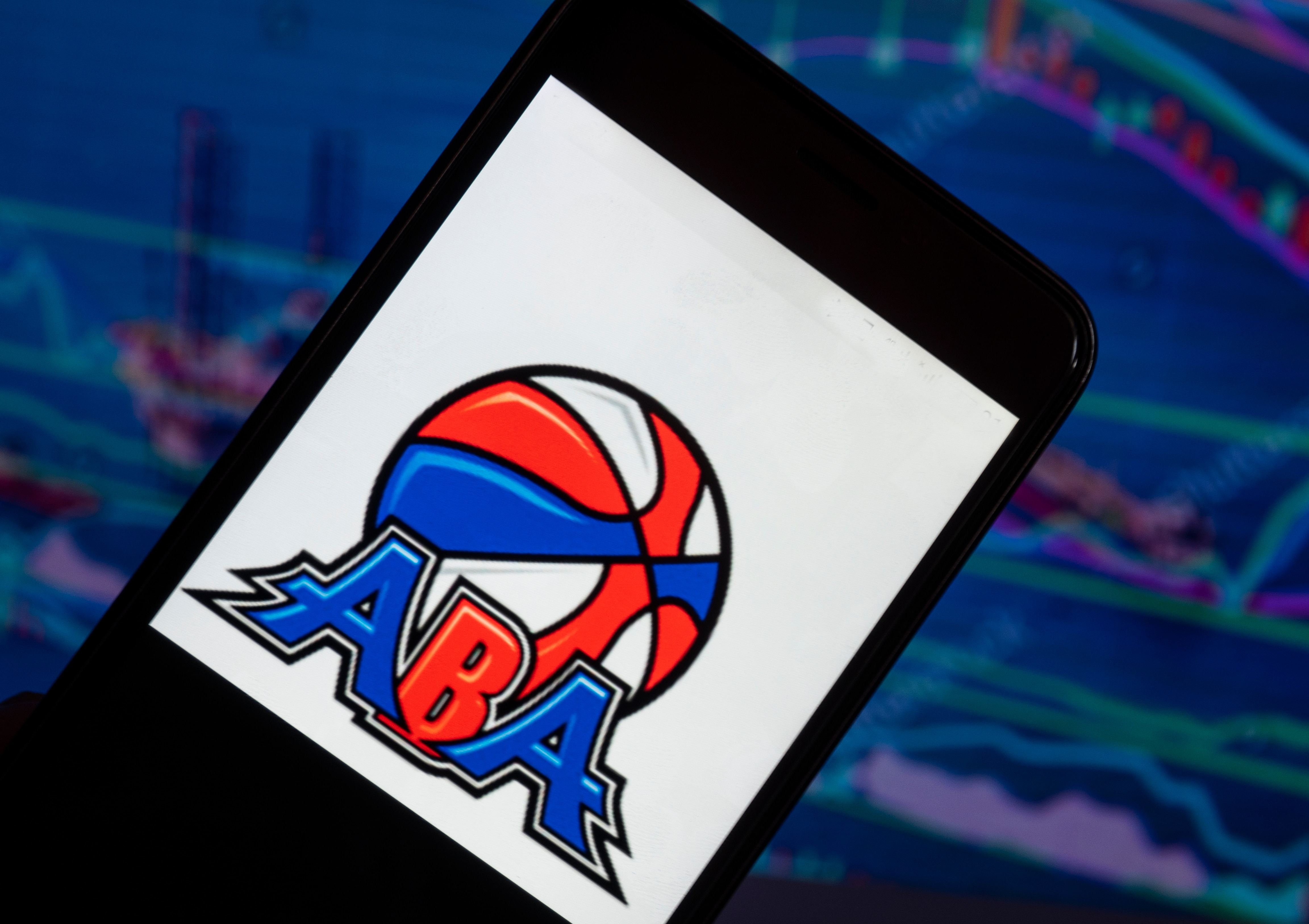 KIEV, UKRAINE - 2018/08/04:  In this photo illustration, the American Basketball Association logo seen displayed on a smartphone. The original American Basketball Association (ABA) was a men's professional basketball league, from 1967 to 1976. The ABA ceased to exist with the American Basketball AssociationNational Basketball Association merger in 1976, leading several teams to join the National Basketball Association and the introduction of the 3-point shot in the NBA. (Photo Illustration by Igor Golovniov/SOPA Images/LightRocket via Getty Images)