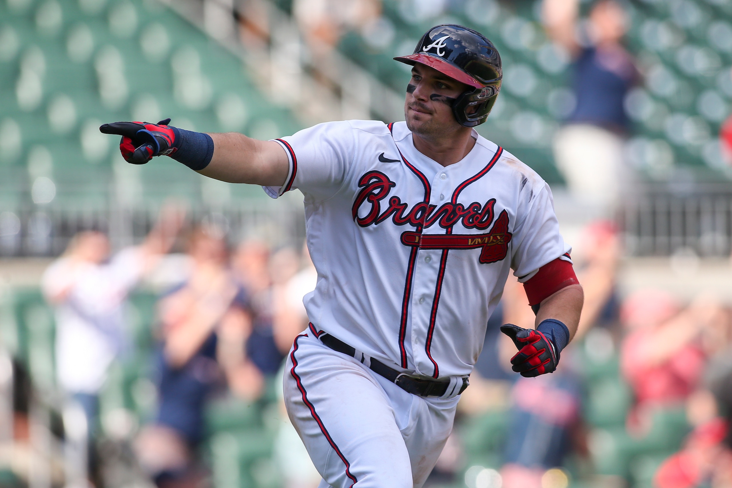 ATLANTA, GA - JULY 10: Austin Riley #27 of the Atlanta Braves celebrates his game-winning single in the 12th inning against the Washington Nationals at Truist Park on July 10, 2022 in Atlanta, Georgia. (Photo by Brett Davis/Getty Images)