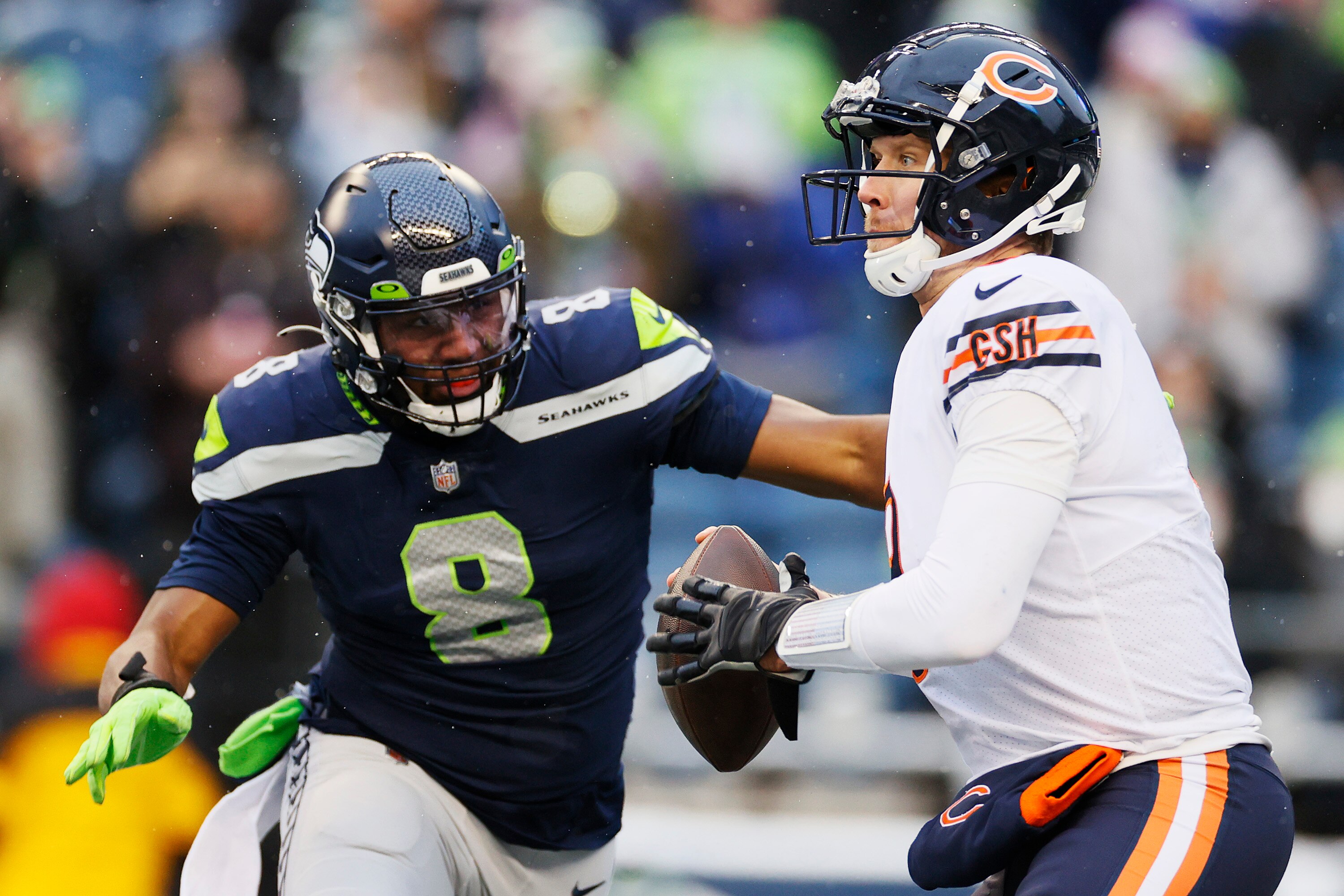 SEATTLE, WASHINGTON - DECEMBER 26: Nick Foles #9 of the Chicago Bears looks to throw the ball as Carlos Dunlap #8 of the Seattle Seahawks applies pressure during the third quarter at Lumen Field on December 26, 2021 in Seattle, Washington. (Photo by Steph Chambers/Getty Images)