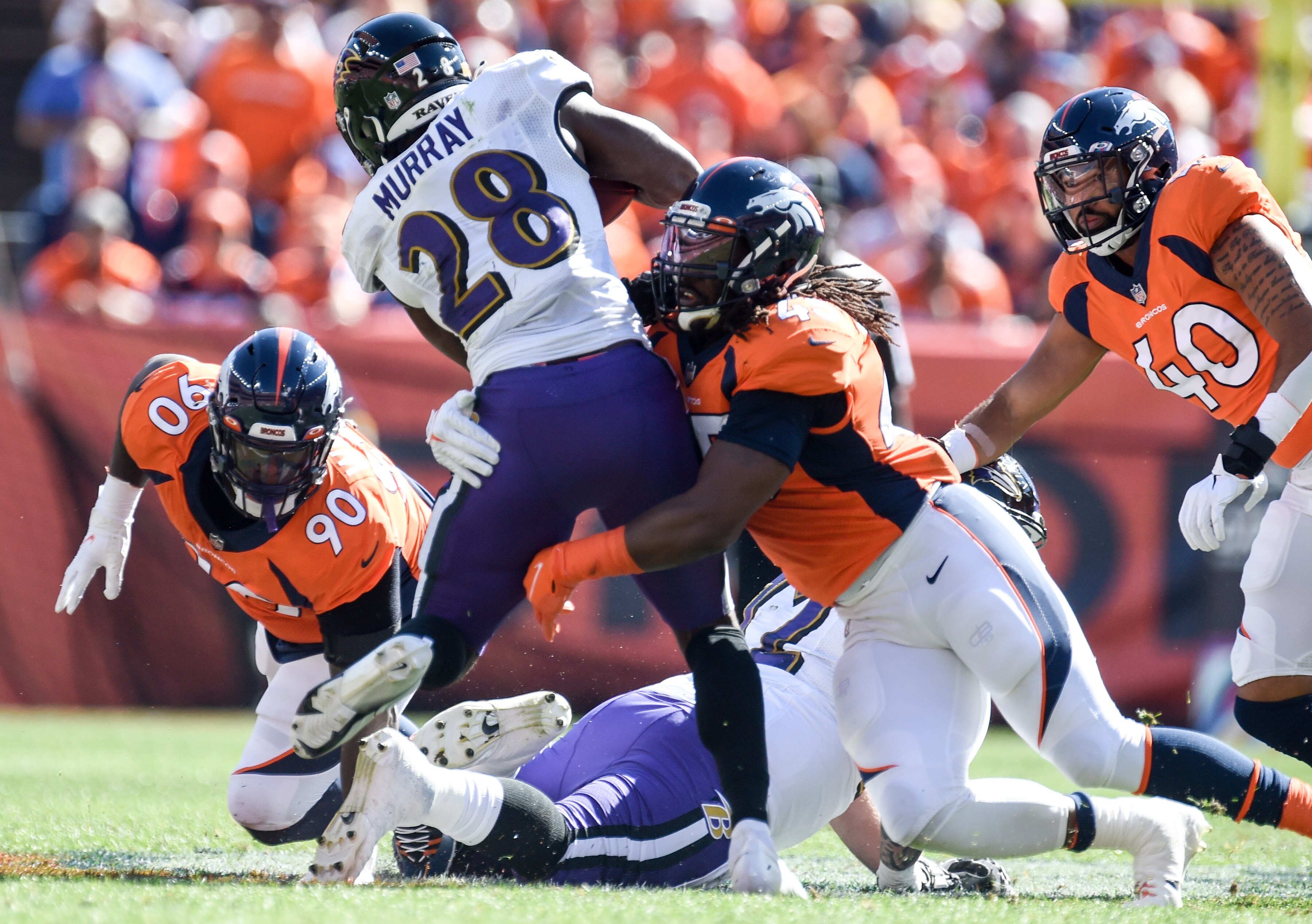 DENVER, CO - SEPTEMBER 3: Denver Broncos linebacker Alexander Johnson (45) makes a stop behind the line on Baltimore Ravens running back Latavius Murray (28) during the first quarter at Empower Field at Mile High on Sunday, September 3, 2021. (Photo by AAron Ontiveroz/MediaNews Group/The Denver Post via Getty Images)
