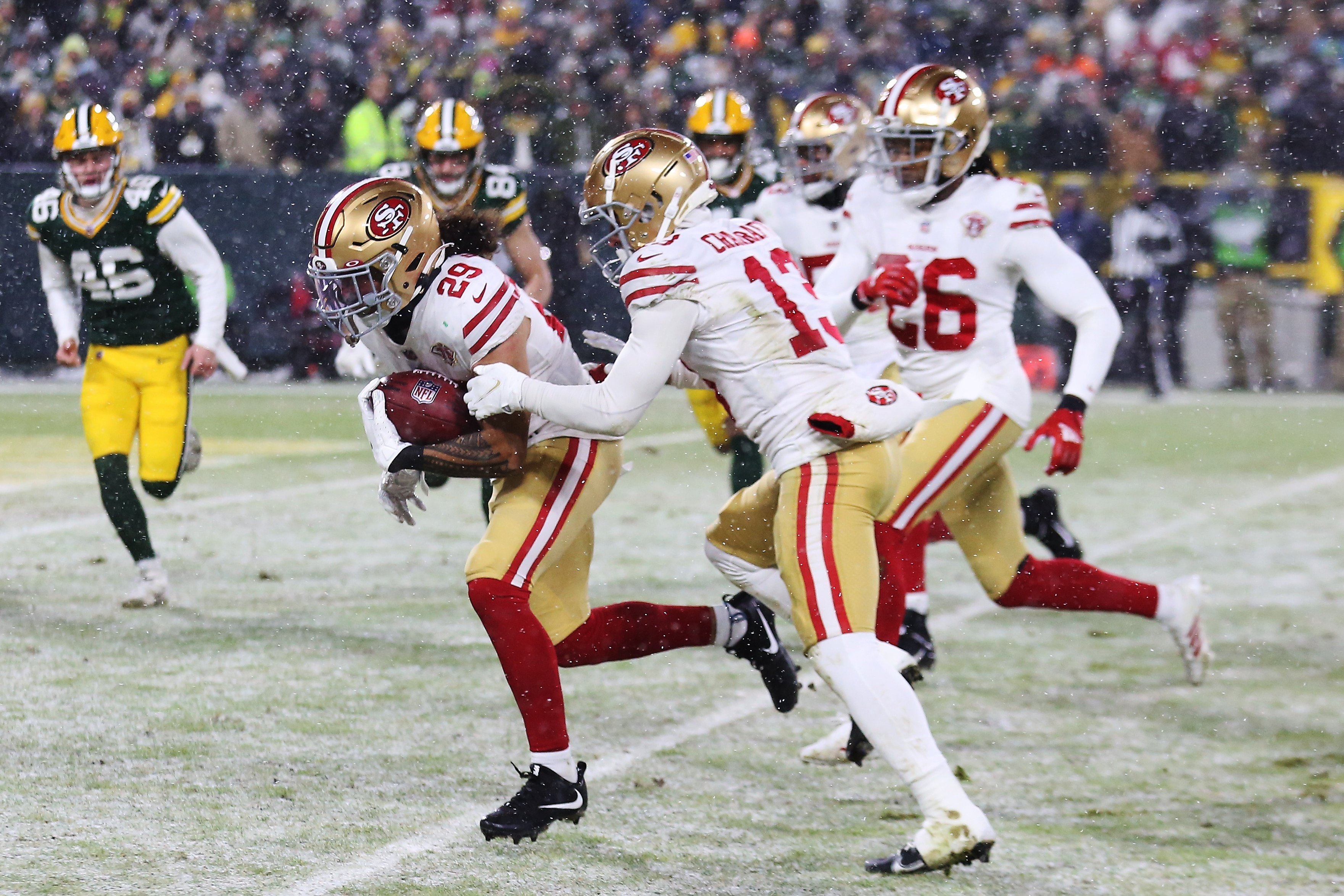 GREEN BAY, WI - JANUARY 22: San Francisco 49ers safety Talanoa Hufanga (29) returns a blocked punt for a touchdown during the NFC Divisional playoff game between the Green Bay Packers and the San Francisco 49ers at Lambeau Field on January 22, 2022, in Green Bay, WI. (Photo by Larry Radloff/Icon Sportswire via Getty Images)